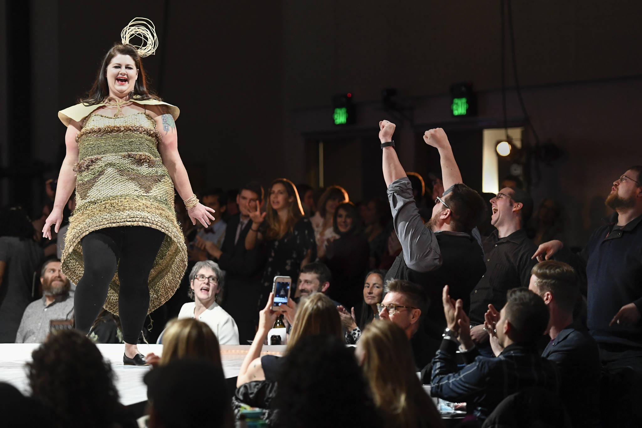 Fans of Jesse Riesenberger give her an enthusiastic cheer as she models Jessica Sullivan’s “Calm in the Wild” at the Wearable Art show at Centennial Hall on Saturday, Feb. 16, 2019. (Michael Penn | Capital City Weekly)