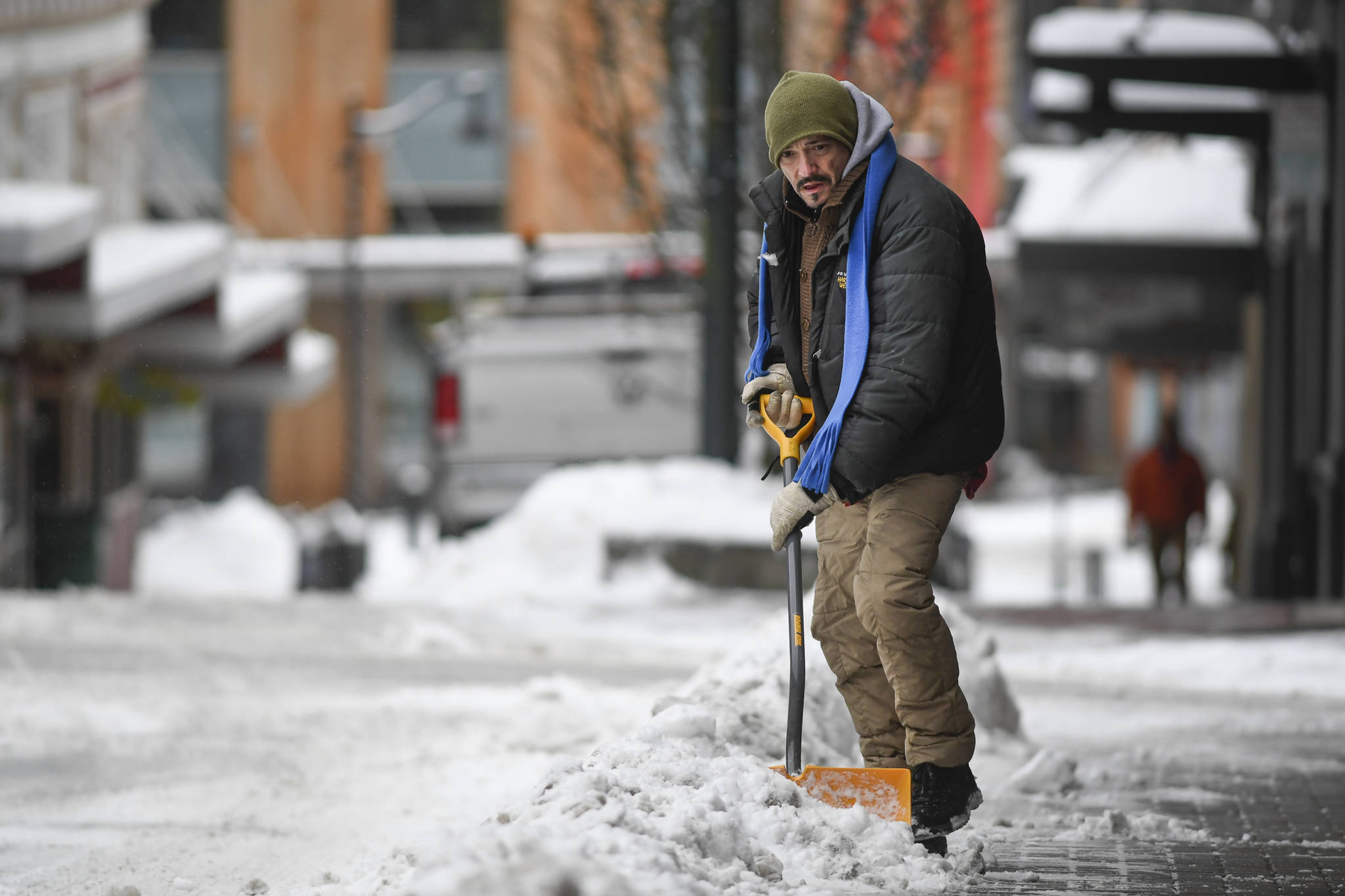 Fate Wilson shovels the sidewalk along Seward Street on Monday, Feb. 18, 2019. The National Weather Service forecasts numerous snow and rain showers for Tuesday with a high temperature in the mid 30s. (Michael Penn | Juneau Empire)