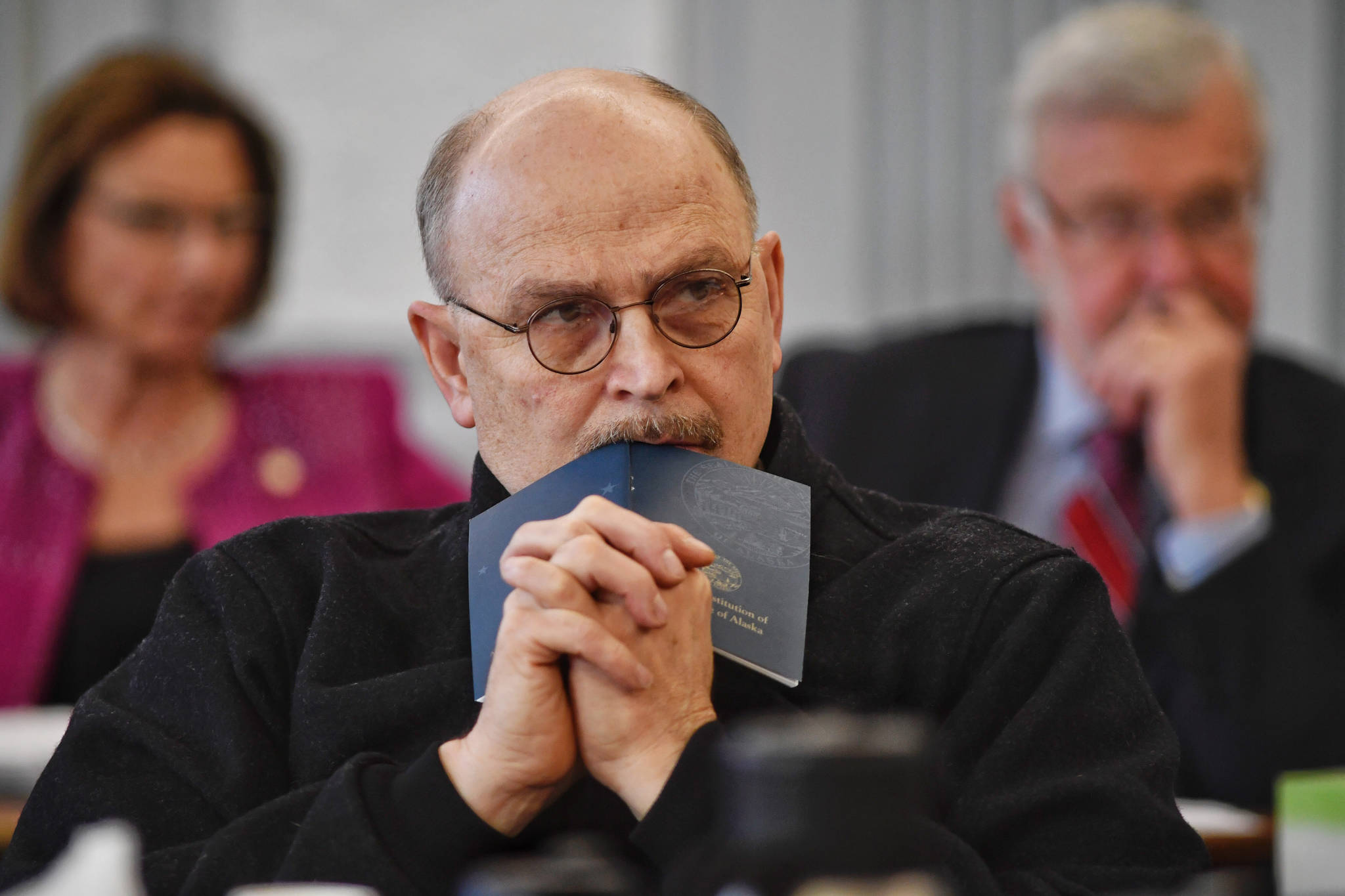 Sen. Click Bishop, R-Fairbanks, rests his head on a Constitution of Alaska booklet as he listens to Donna Arduin, Director of the Office of Management and Budget, and Mike Barnhill, policy director for the OMB, continue to present Gov. Mike Dunleavy’s budget to the Senate Finance Committee at the Capitol on Tuesday, Feb. 18, 2019. Senate President Cathy Giessel, R - Anchorage, left, and Sen. Gary Stevens, R-Kodiak, right, are in the background. (Michael Penn | Juneau Empire)