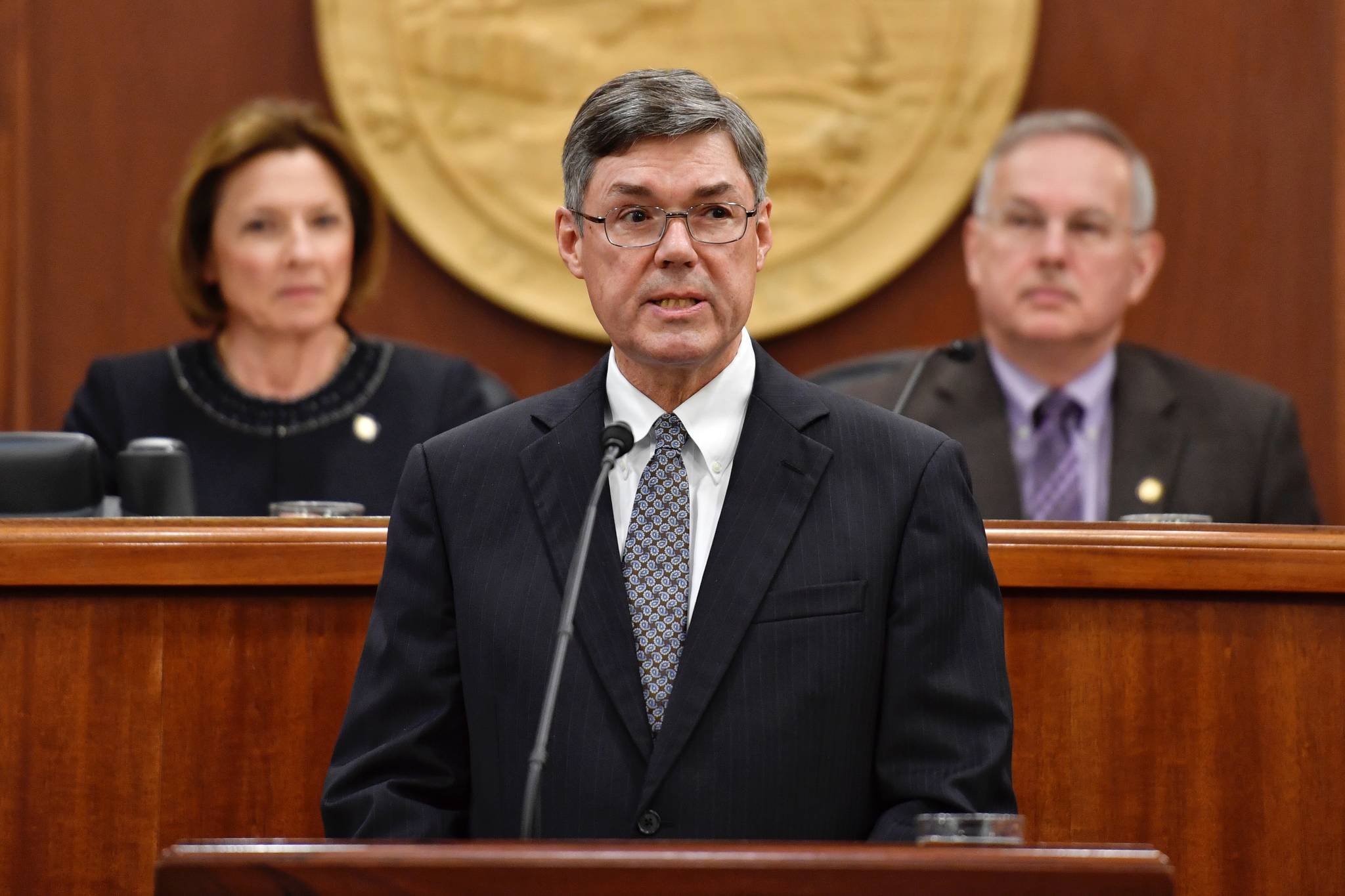 Alaska Supreme Court Chief Justice Joel H. Bolger speaks to a Joint Session of the Alaska Legislature at the Capitol on Wednesday, Feb. 19, 2019. Senate President Cathy Giessel, R-Anchorage, and Speaker of the House Bryce Edgmon, D-Dillingham, listen from the Speaker’s desk in the House of Representatives. (Michael Penn | Juneau Empire)