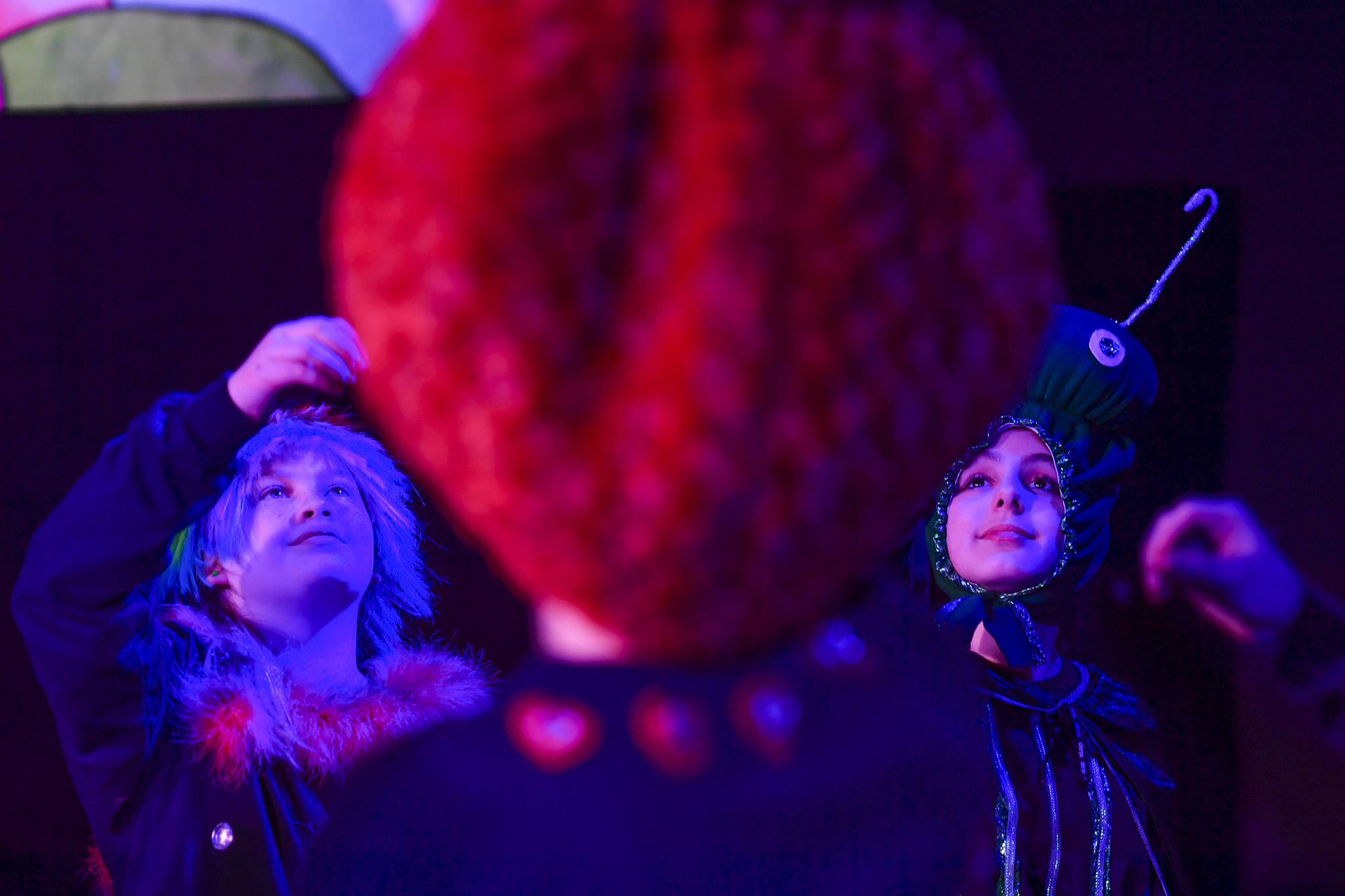 Paige Kirsch, left, and Cadence Ward, as the Caterpillar, perform the Mad Tea Party scene from “DISCO ALICE: The Wonderland Remix” during rehearsal by Perseverance Theatre’s Young Company on Monday, Feb. 25, 2019. (Michael Penn | Juneau Empire)