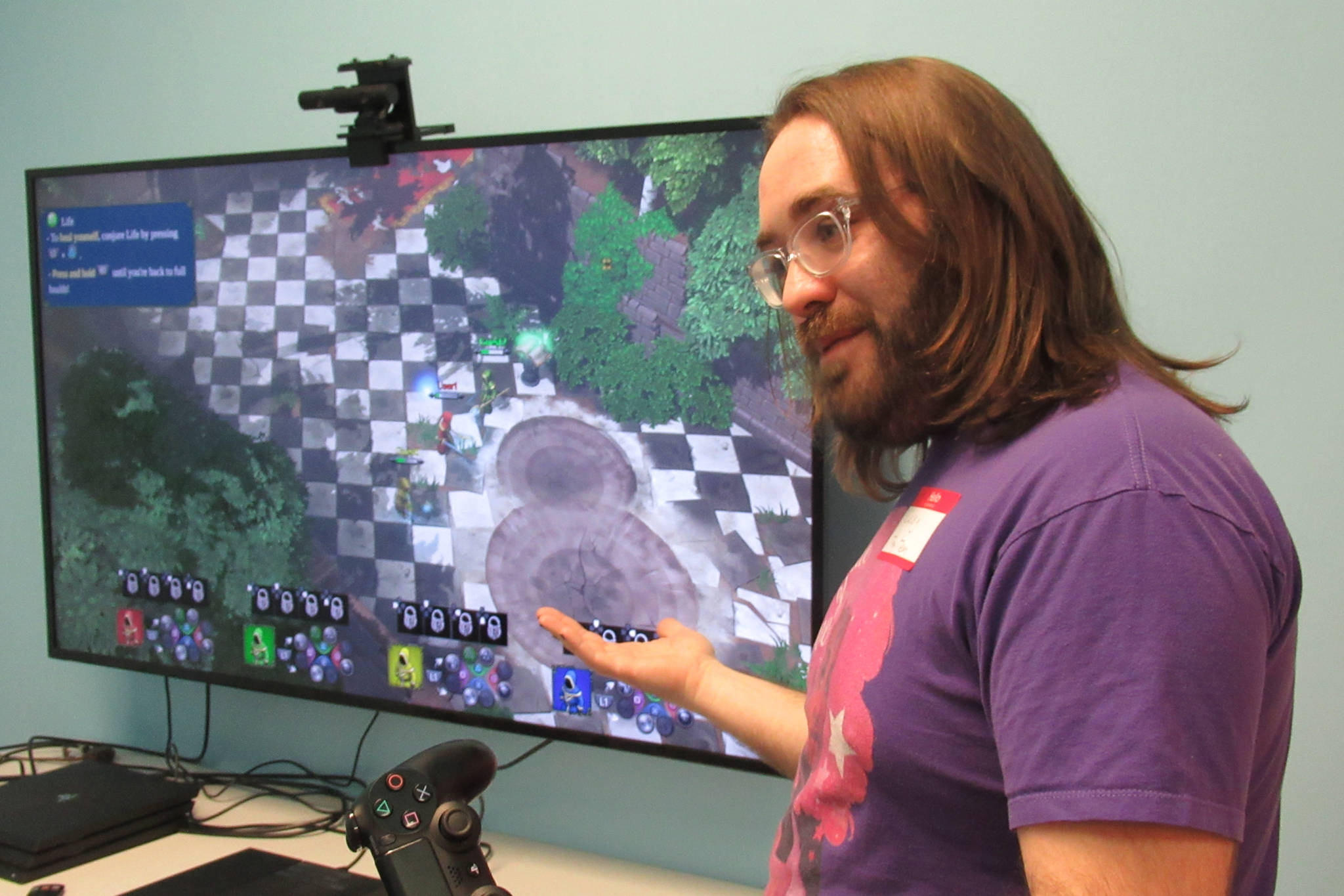 Casey Harris, co-owner of Game On, explains how to play a game during the first Trans Gaming Night at Game On, Saturday, Feb. 23, 2019. (Ben Hohenstatt | Capital City Weekly)