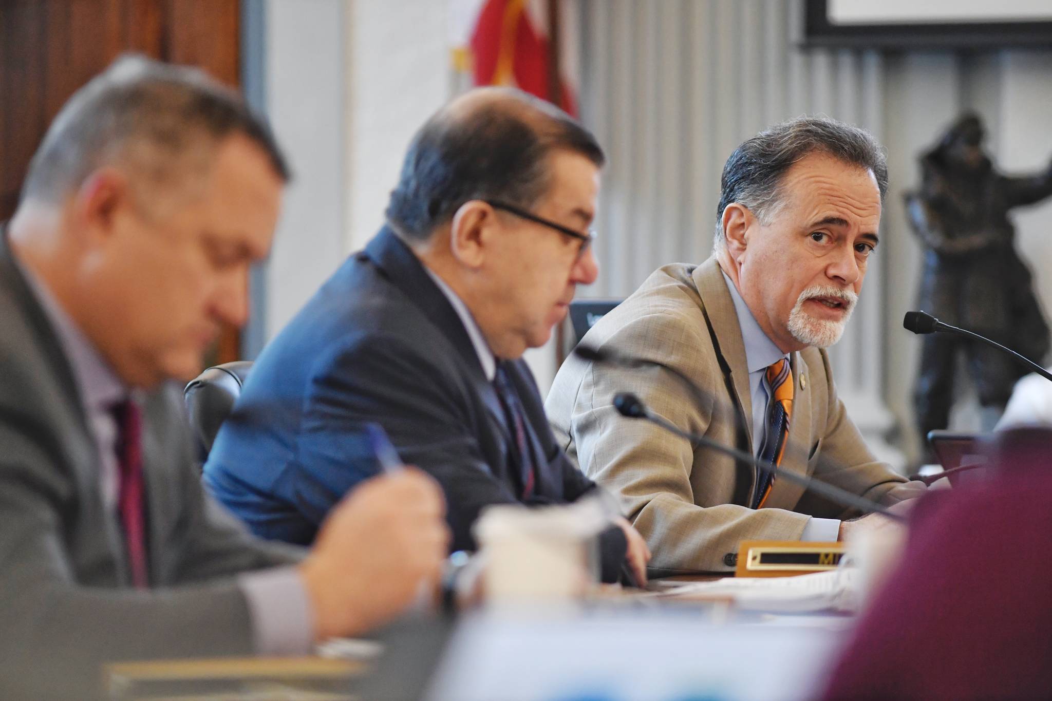 Sen. Peter Micciche, R-Soldotna, right, asks a questionduring a Senate Finance Committee meeting with Lacey Sanders, Budget Director for the Office of Management and Budget, about consolidation of department positions on Monday, Feb. 25, 2019. Sen. Lyman Hoffman, D-Bethel, center, and Sen. Mike Shower, R-Wasilla, left, are also shown. (Michael Penn | Juneau Empire)
