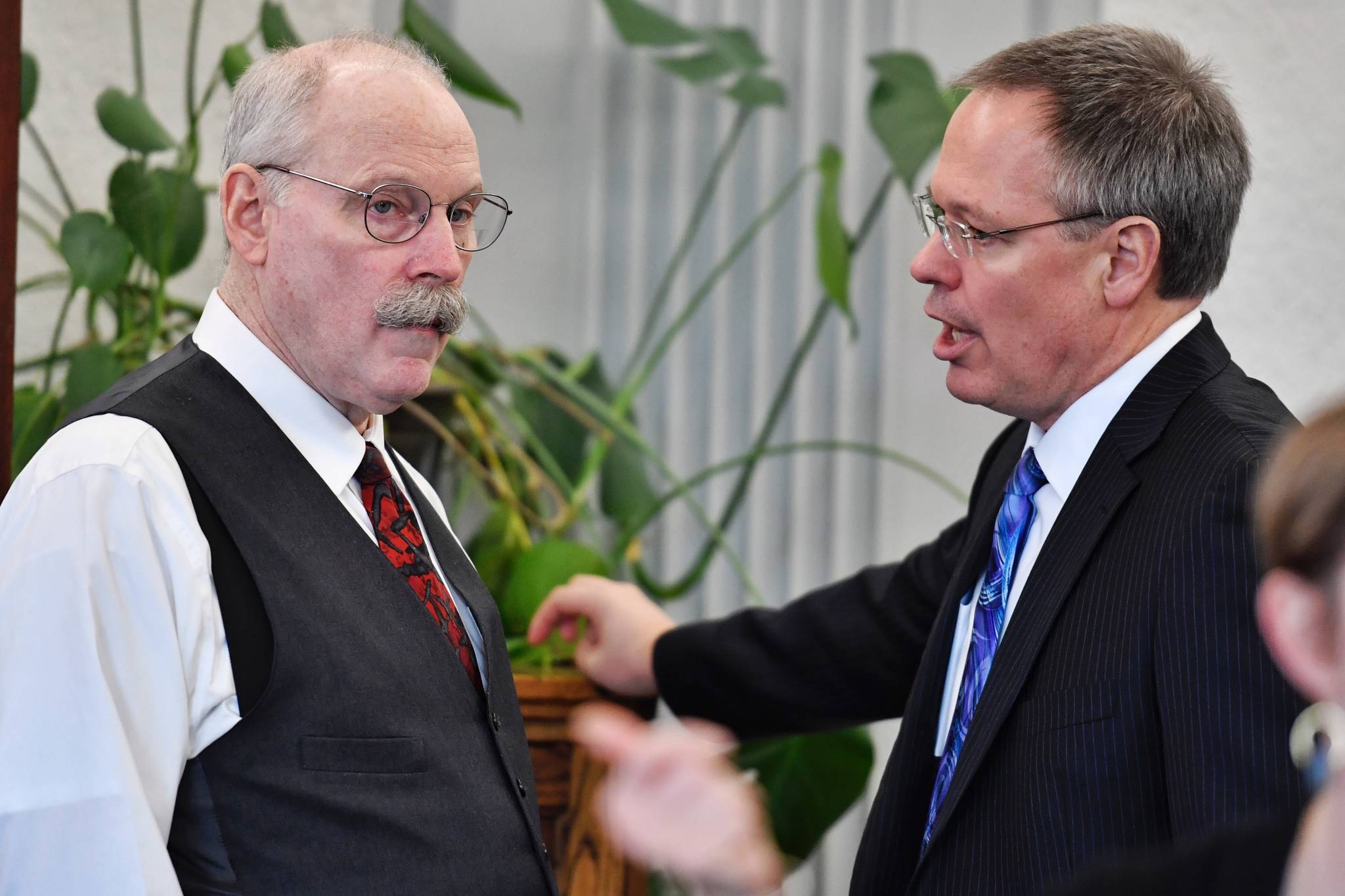 Bruce Tangeman, Commissioner of Revenue, right, speaks with Sen. Bert Stedman, R-Sita, Co-Chair of the Senate Finance Committee, before their committee meeting at the Capitol on Thursday, Feb. 28, 2019. (Michael Penn | Juneau Empire)