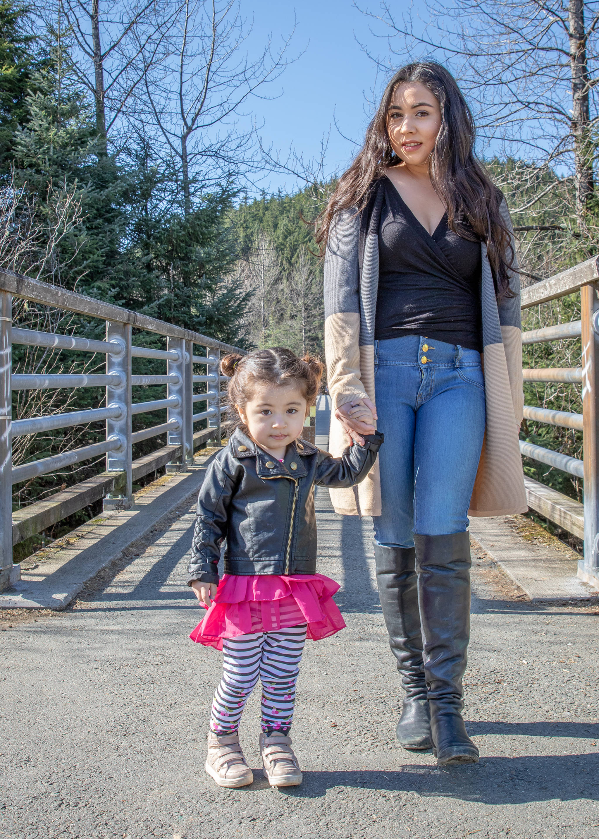 March 31, 2019: Everyone enjoys a walk on a sunny day, and Michelle Cabrera and her daughter Ariana do so in style. Michelle is wearing an Anne Klein cardigan over a Banana Republic top and Style & Co jeans, with black leather Vince Camuto boots. Ariana couldn’t be cuter in her outfit from Juicy Couture topped by a black leather jacket.