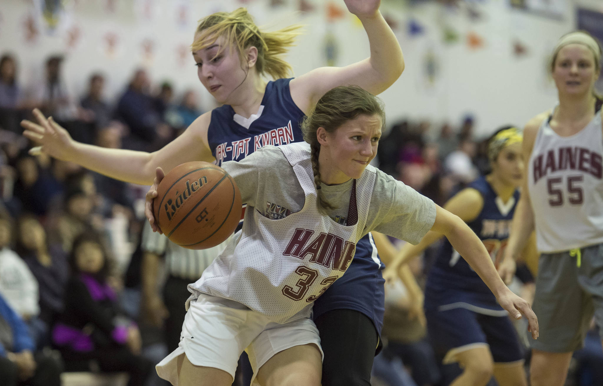 In this March 24, 2018 photo, Haines Christine Hansen drives against Yakutats Janie Jensen during the Womens final in the Juneau Lions Club Gold Medal Basketball Tournament at Juneau-Douglas High School. (Michael Penn | Juneau Empire File)