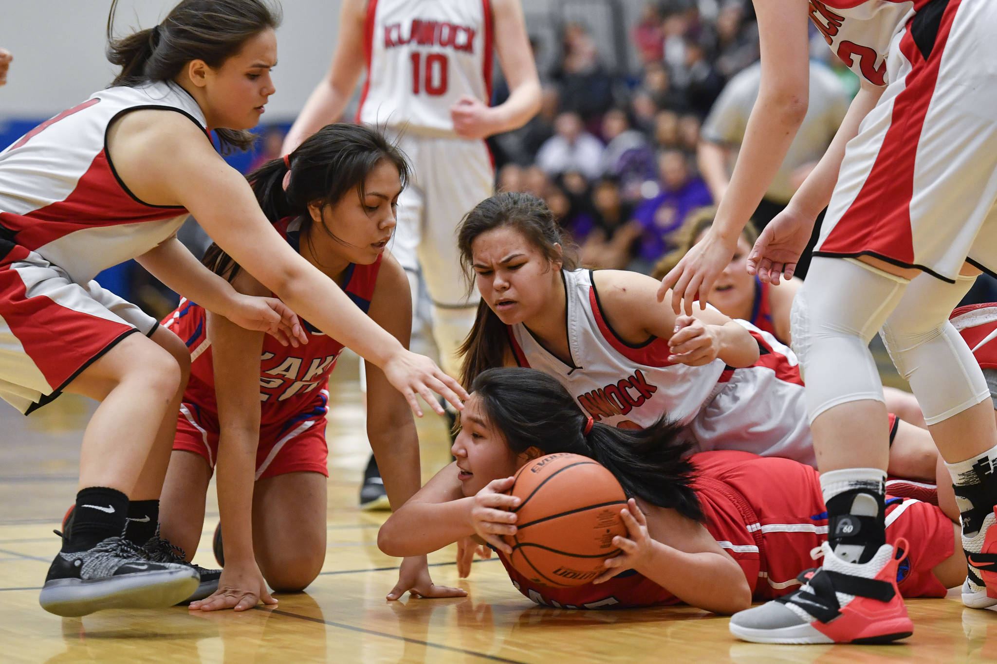 Kake’s Felicia Ross-Shaquanie, right, grabs the ball in a scrum with teammate Alexis Copsey and Klawock’s Valory Smith-Turpin, left, and Malory Smith-Turpin in the finals of the Region V 1A Basketball Championships at Thunder Mountain High School on Friday, March 1, 2019. Klawock won 47-46. (Michael Penn | Juneau Empire)