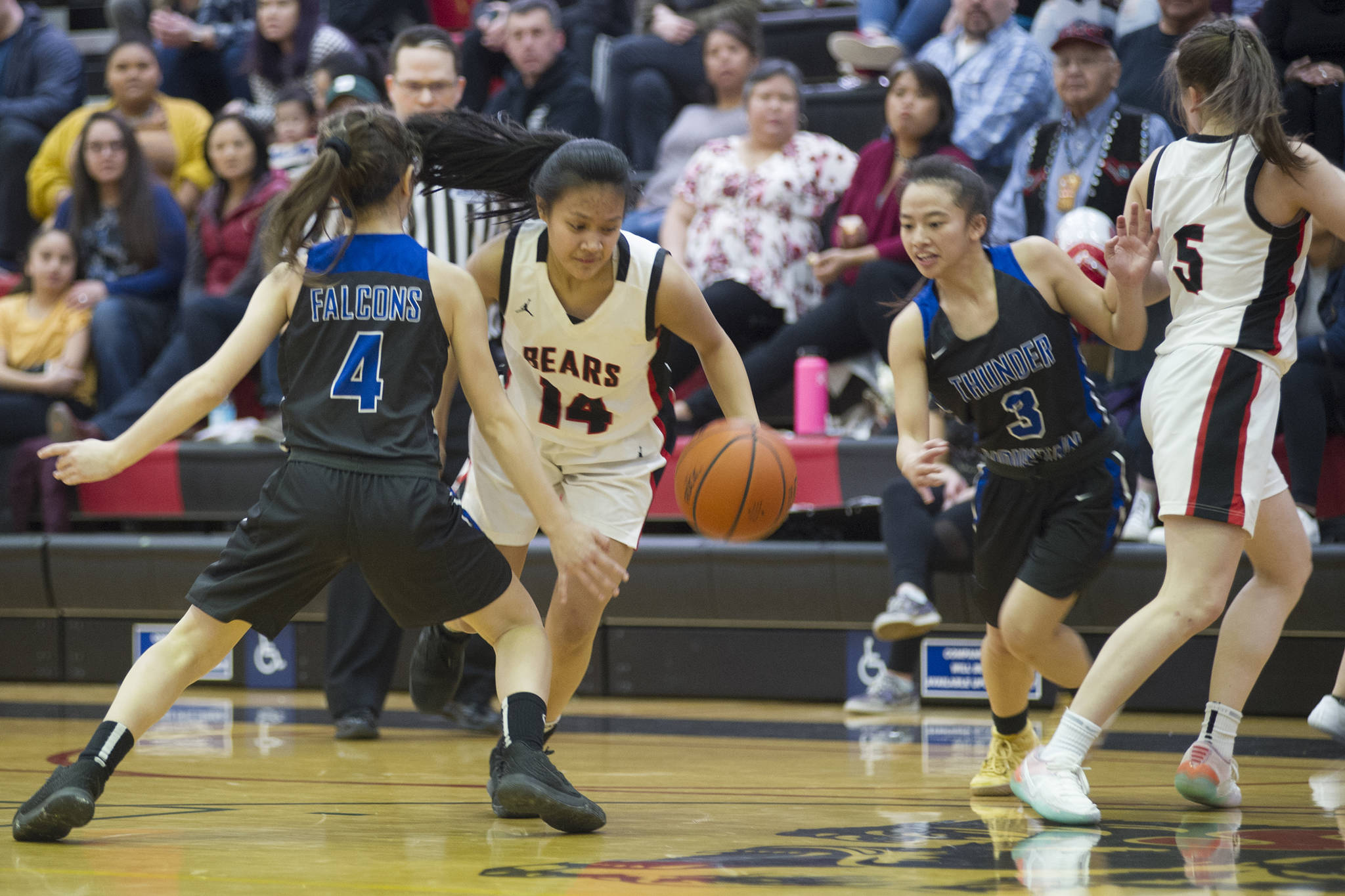 Juneau-Douglas’ Alyxn Bohulano dribbles in between Thunder Mountain’s Johanna Pasion, left, and Neal Garcia in the first half at JDHS Saturday, March 2, 2019. (Nolin Ainsworth | Juneau Empire)