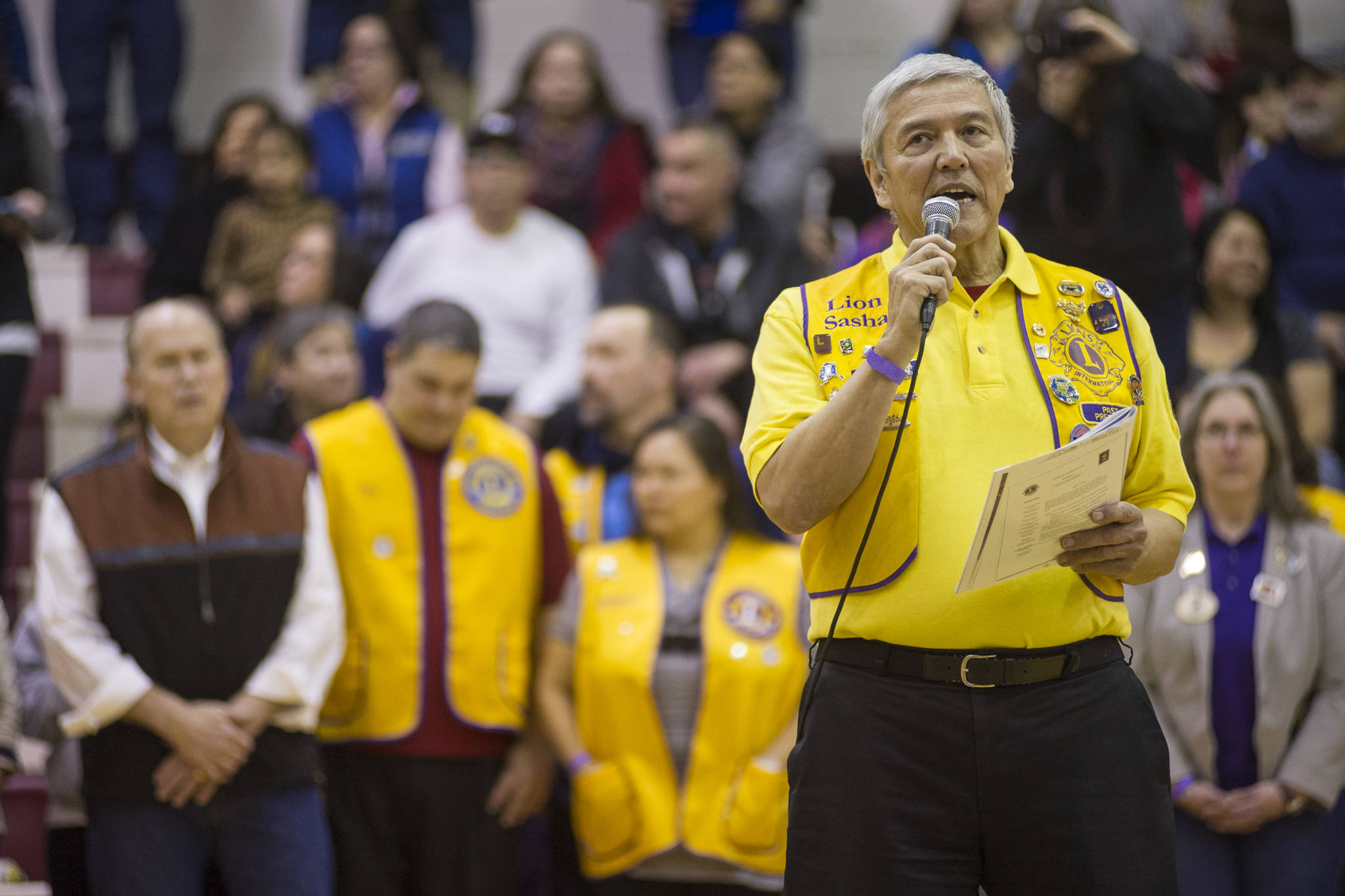 In this March 16, 2015 photo, Sasha Soboleff, past president of the Juneau Lions Club, introduces Gov. Bill Walker, left, during opening ceremonies of the Juneau Lions Club Gold Medal Basketball Tournament at Juneau-Douglas High School. (Michael Penn | Juneau Empire File)