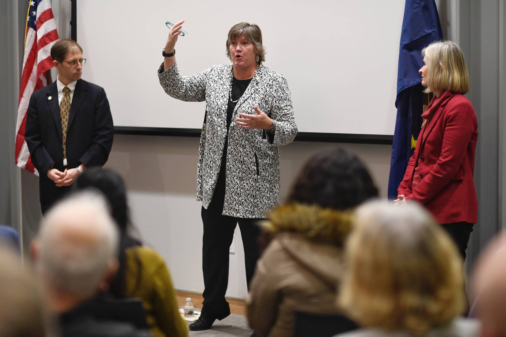 In this file photo, Rep. Sara Hannan, D-Juneau, center, answers a question as Sen. Jesse Kiehl, D-Juneau, left, and Rep. Andi Story, D-Juneau, wait their turn during a standing-room only town hall meeting at the Mendenhall Valley Public Library on Tuesday, Jan. 29, 2019. (Michael Penn | Juneau Empire)