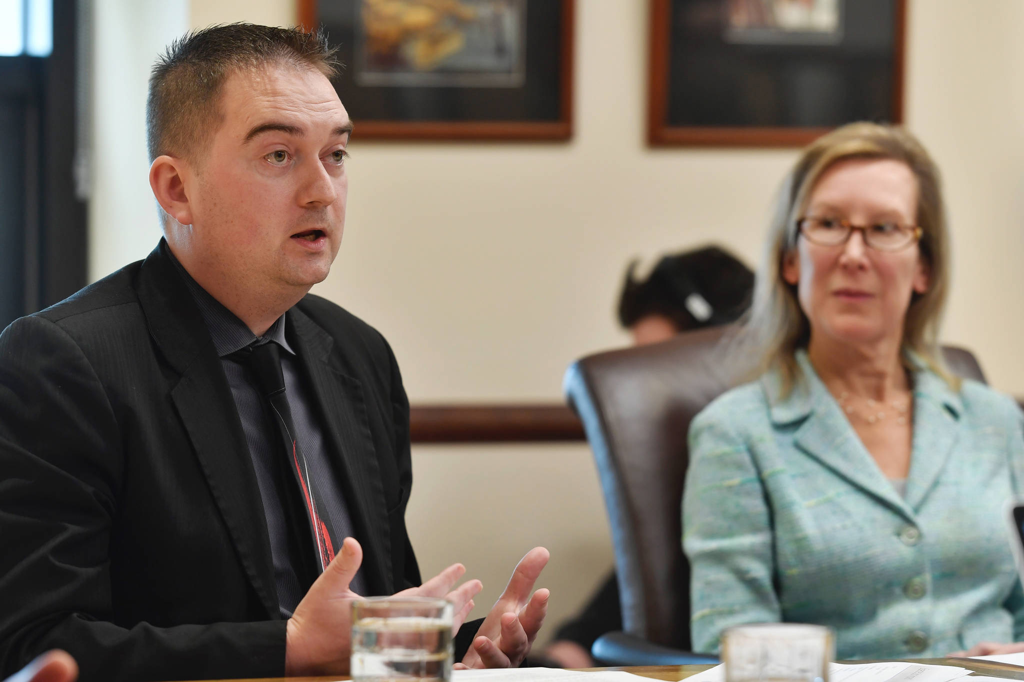 Edward King, Chief Economist for the Department of Revenue, and Donna Arduin, Director of the Office of Management and Budget, speak to members of the media at the Capitol on Wednesday, March 6, 2019. (Michael Penn | Juneau Empire)