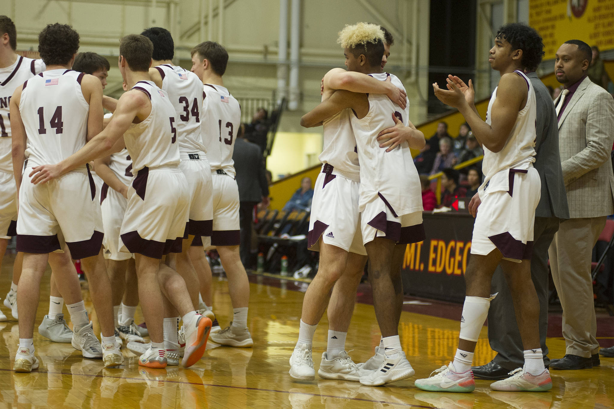 The Ketchikan boys basketball team celebrates its 65-60 victory over Juneau-Douglas in the Region V 4A championship game at the B.J. McGillis Gymnasium at Mt. Edgecumbe High School on Friday, March 8, 2019. (Nolin Ainsworth | Juneau Empire)