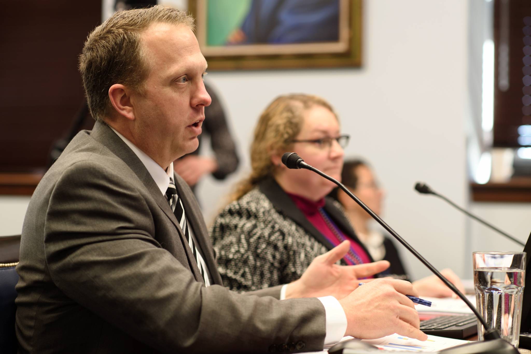 Matt McLaren, Business and Development Manager for the Alaska Marine Highway System, and Amanda Holland, Management Director for the Office of Management and Budget, make a presentation to the Senate Transportation Committee at the Capitol on Thursday, March 7, 2019. (Michael Penn | Juneau Empire)