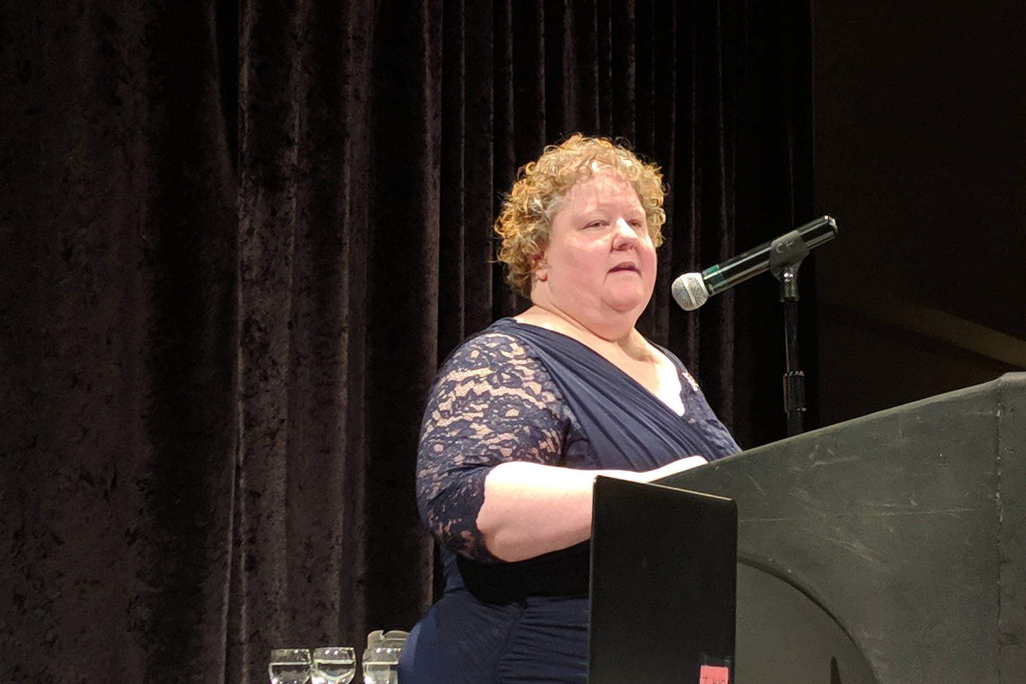 Kathryn Beers speaks at the Woman of Distinction 2019 Celebration Saturday, March 9, 2019, at Centennial Hall. Beers shared her firsthand account of the difference Aiding Women in Abuse and Rape Emergencies (AWARE) had in her life. (Ben Hohenstatt | Capital City Weekly)