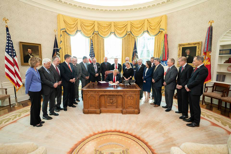 President Donald Trump, joined by Rep. Debbie Dingell, D-Michigan, signs S.47: The John D. Dingell, Jr. Conservation, Management and Recreation Act on Tuesday in the Oval Office of the White House. (Shealah Craighead | White House)
