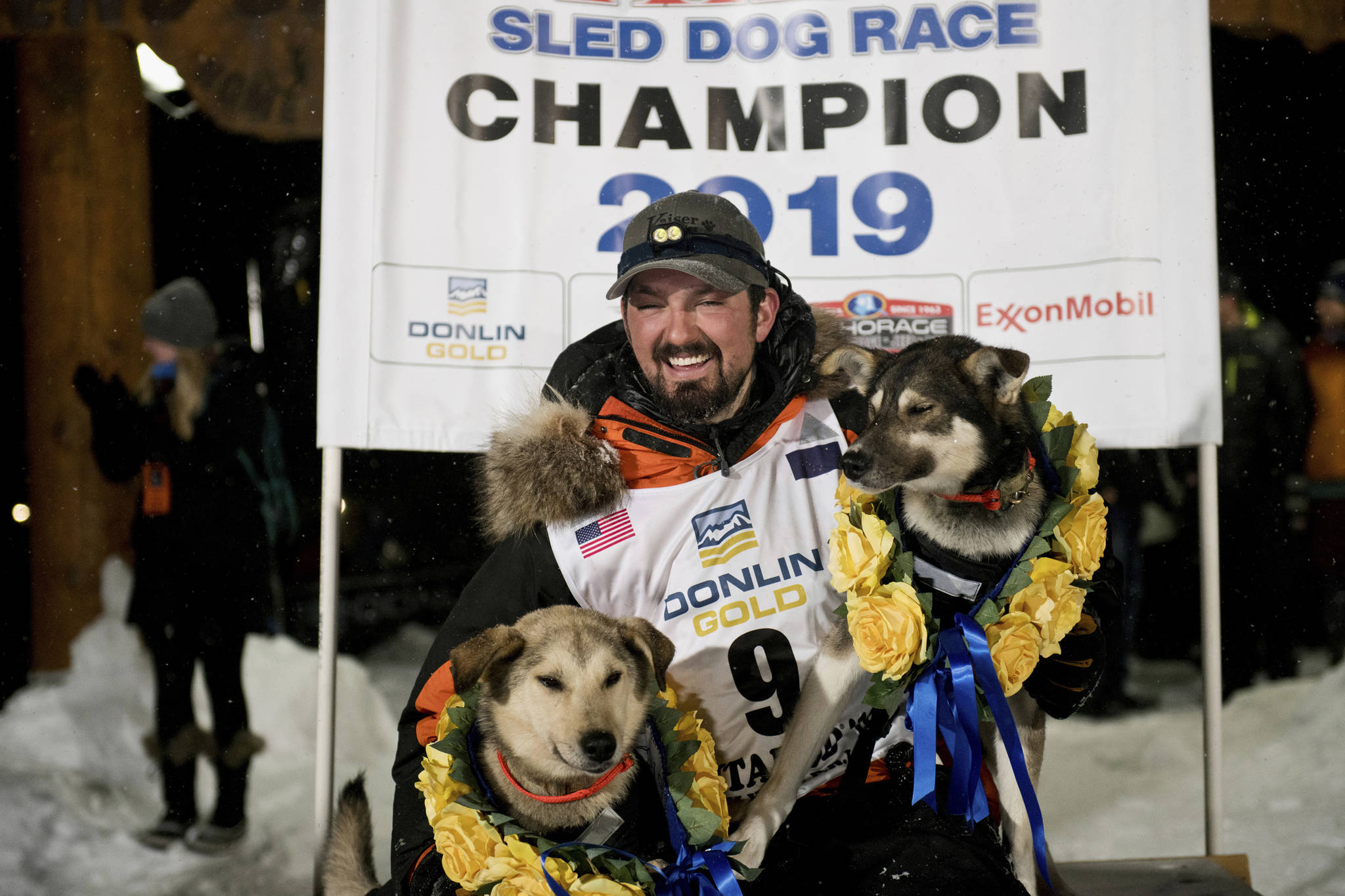 Peter Kaiser poses with his lead dogs, Morrow, left, and Lucy on Wednesday, March 13, 2019, in Nome, Alaska, after winning the Iditarod Trail Sled Dog Race. It’s the first Iditarod victory for Kaiser in his 10th attempt. (Marc Lester | Anchorage Daily News)
