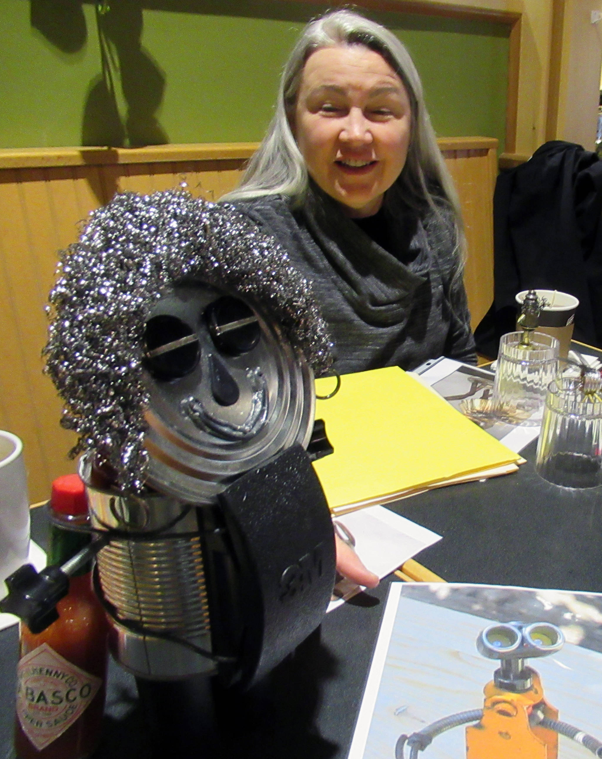 Rotarian Diane Kyser smile said she was able to create her smiley, curly-haired statue in a single morning although a load-bearing bottle of Tabasco sauce was required to keep it standing, Tuesday, March 12, 2019. (Ben Hohenstatt | Juneau Empire)