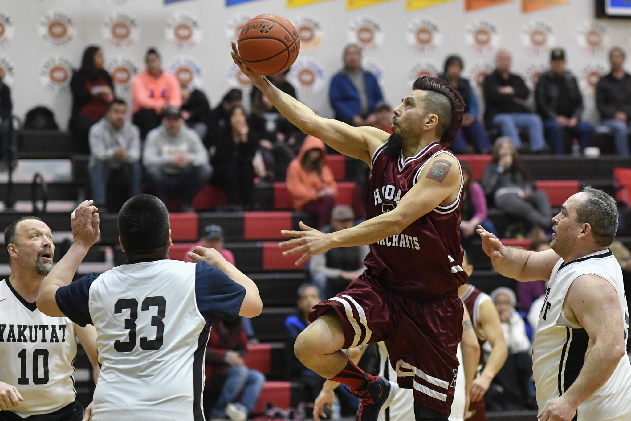 Hoonah’s Marti Fred sails to the basket over Hoonah in the Masters bracket game at the Gold Medal Basketball Tournament on Thursday, March 21, 2019. (Michael Penn | Juneau Empire)