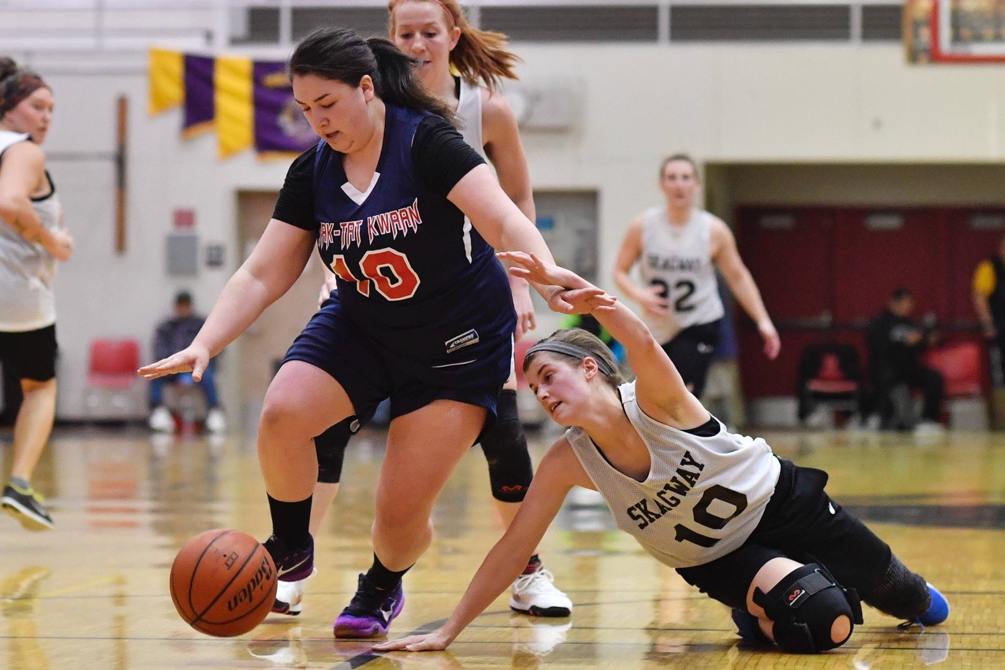 Yakutat’s Nadine Fraker, left, dribbles away from Skagway’s Kaylie Smith during their women’s bracket game at the Lions Club’s Gold Medal Basketball Tournament on Thursday, March 21, 2019. (Michael Penn | Juneau Empire)