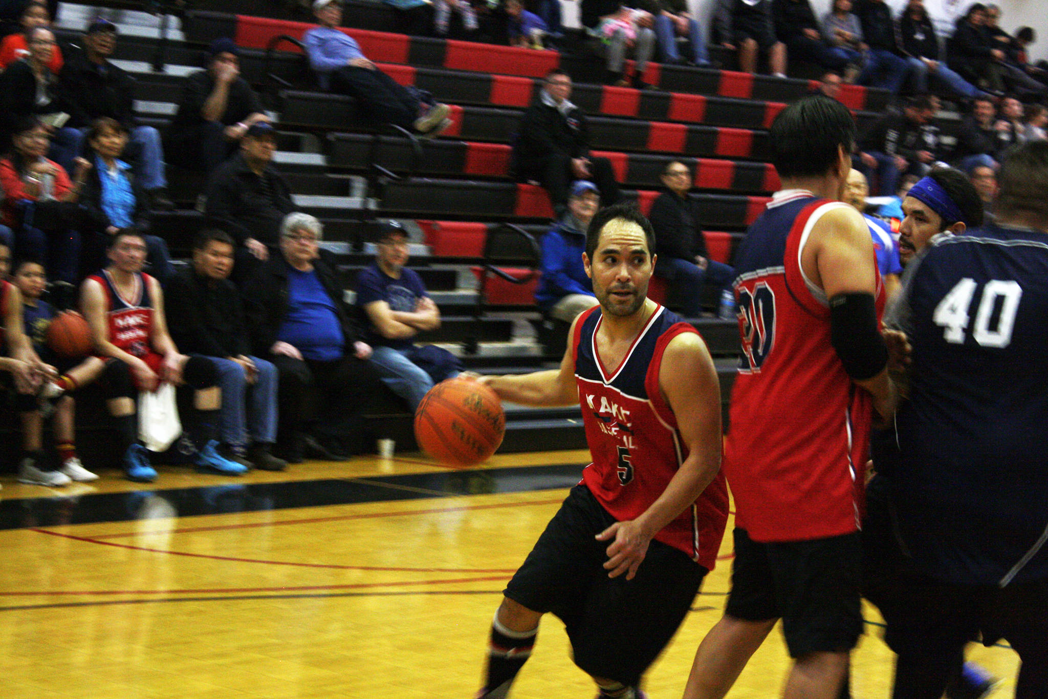 Rudy Bean dribbles the ball during Kakes big win over Angoon that kicked off Mondays action for the Gold Medal Basketball Tournament. (Ben Hohenstatt | Juneau Empire)