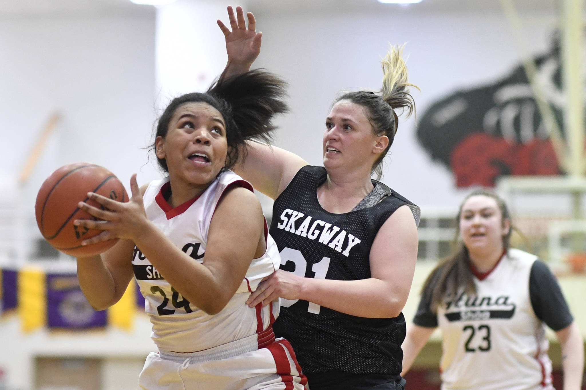 Hoonah’s Zhane White, left, is guarded closely by Skagway’s Tiffanie Ames at the Juneau Lions Club 73rd Annual Gold Medal Basketball Tournament at Juneau-Douglas High School: Yadaa.at Kalé on Tuesday, March 19, 2019. Skagway won 80-42. (Michael Penn | Juneau Empire)