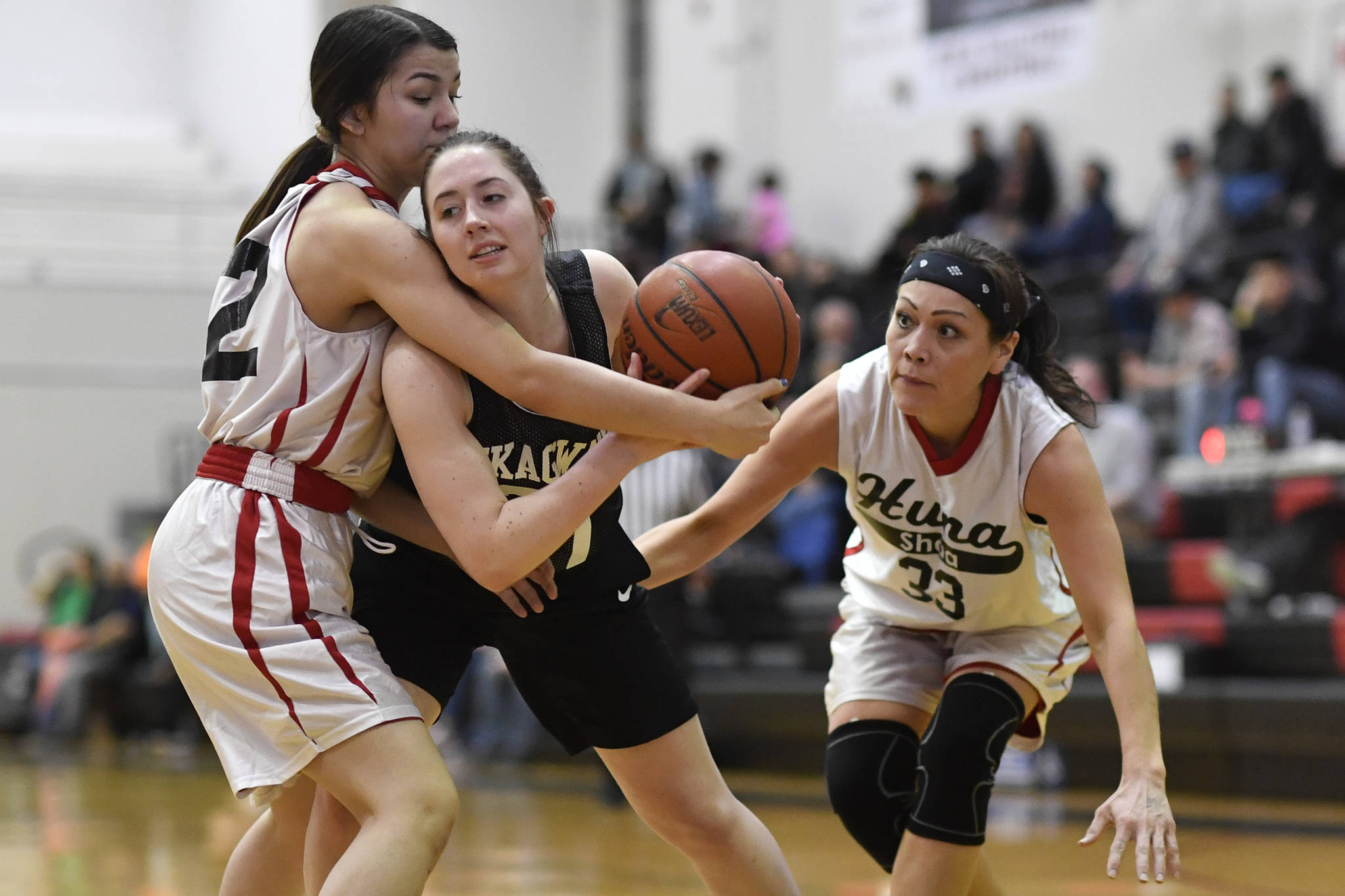 Skagway’s Hailey Jensen, center, is closely guarded by Hoonah’s Ronnie Roberts, left, and Krissy Benn at the Juneau Lions Club 73rd Annual Gold Medal Basketball Tournament at Juneau-Douglas High School: Yadaa.at Kalé on Tuesday, March 19, 2019. Skagway won 80-42. (Michael Penn | Juneau Empire)