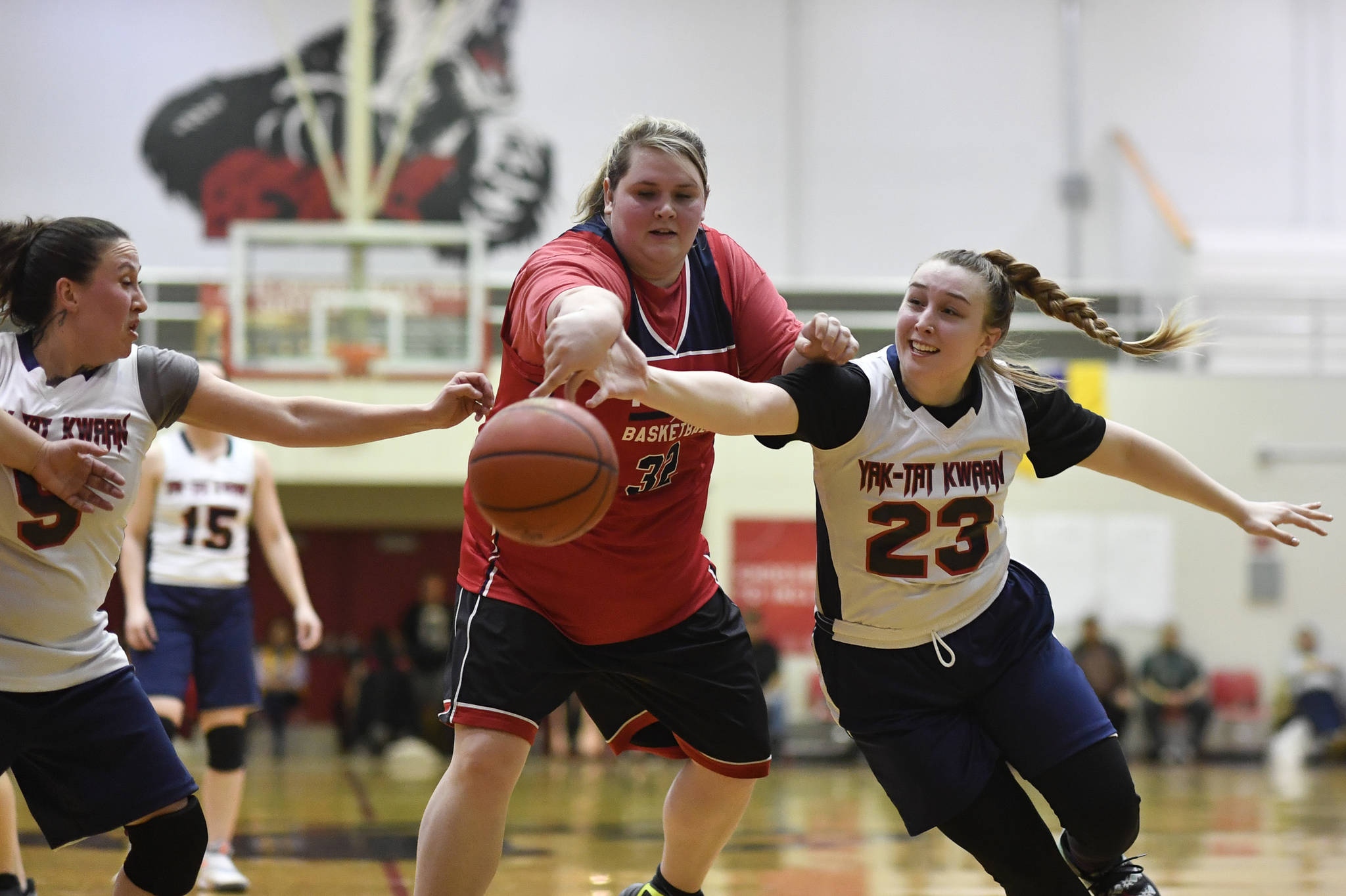Kake’s Paulette Aceveda, center, reaches for a loose ball against Yakutat’s Janie Jensen, right, and Kim Buller, left, at the Juneau Lions Club 73rd Annual Gold Medal Basketball Tournament at Juneau-Douglas High School: Yadaa.at Kalé on Tuesday, March 19, 2019. Yakutat won 64-48. (Michael Penn | Juneau Empire)