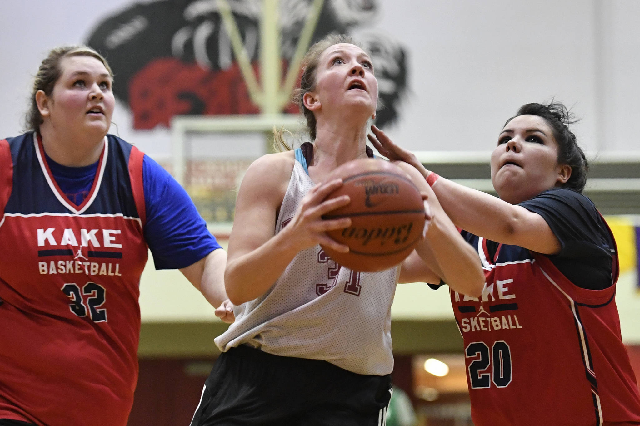 Haines’ Rachel Brittenham drives to the basket against Kake’s Monica Ashenfelter, left, and Hannah Ashenfelter at the Juneau Lions Club 73rd Annual Gold Medal Basketball Tournament at Juneau-Douglas High School: Yadaa.at Kalé on Wednesday, March 20, 2019. Haines won 67-20. (Michael Penn | Juneau Empire)
