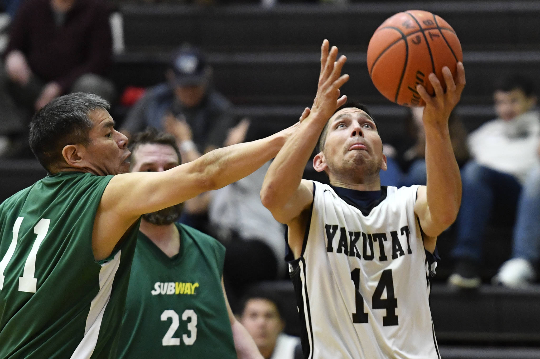Yakutat’s Ralph Johnson, left, shoots against Sitka’s Ray Kitka in a masters bracket game at the Juneau Lions Club 73rd Annual Gold Medal Basketball Tournament at Juneau-Douglas High School: Yadaa.at Kalé on Wednesday, March 20, 2019. Yakutat won 66-49. (Michael Penn | Juneau Empire)