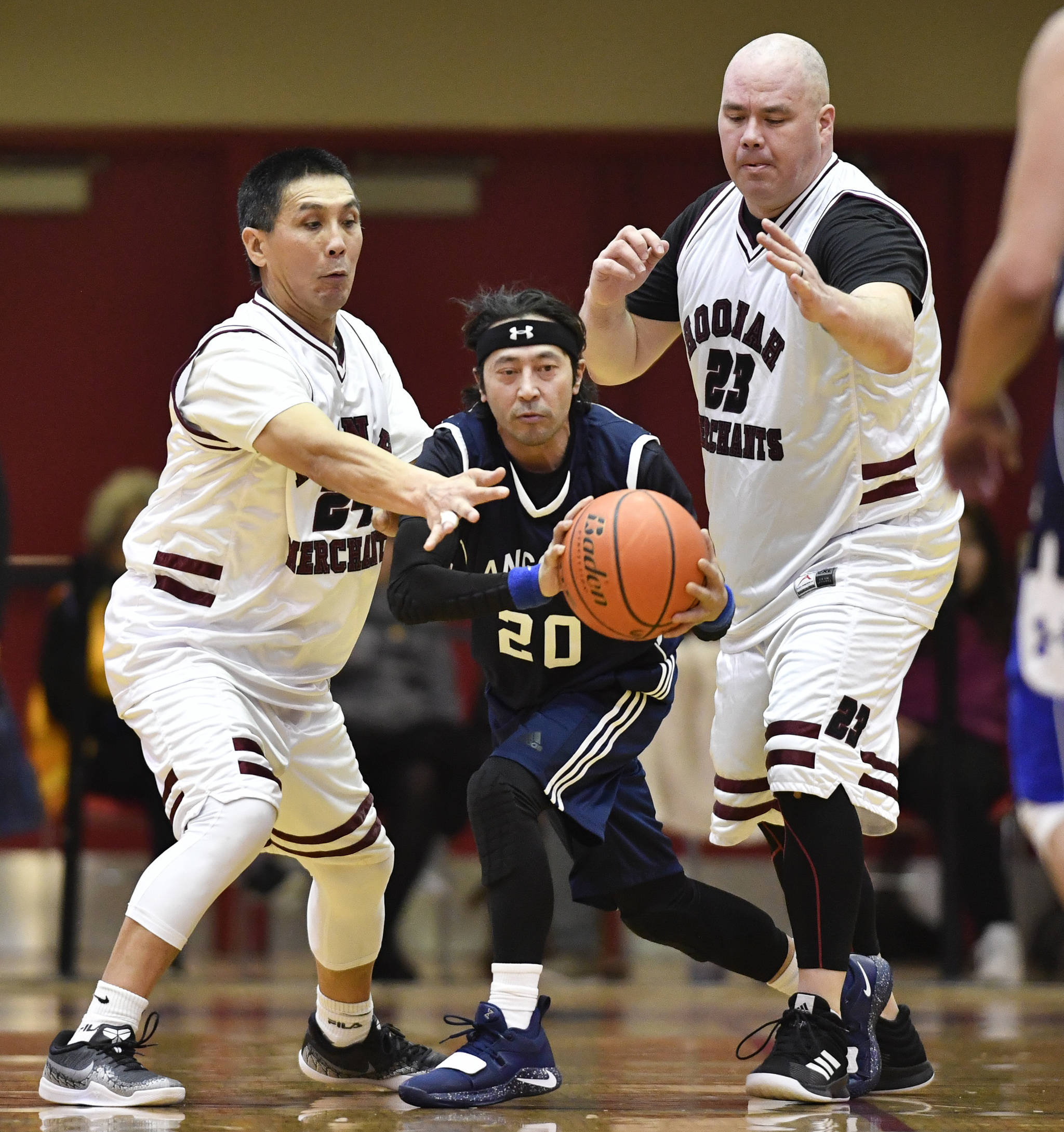 Angoon’s Sterling Bolima, center, is trapped by Hoonah’s Ken Willard Jr., left, and Andy Gray in a masters bracket game at the Juneau Lions Club 73rd Annual Gold Medal Basketball Tournament at Juneau-Douglas High School: Yadaa.at Kalé on Wednesday, March 20, 2019. Hoonah won 75-44. (Michael Penn | Juneau Empire)