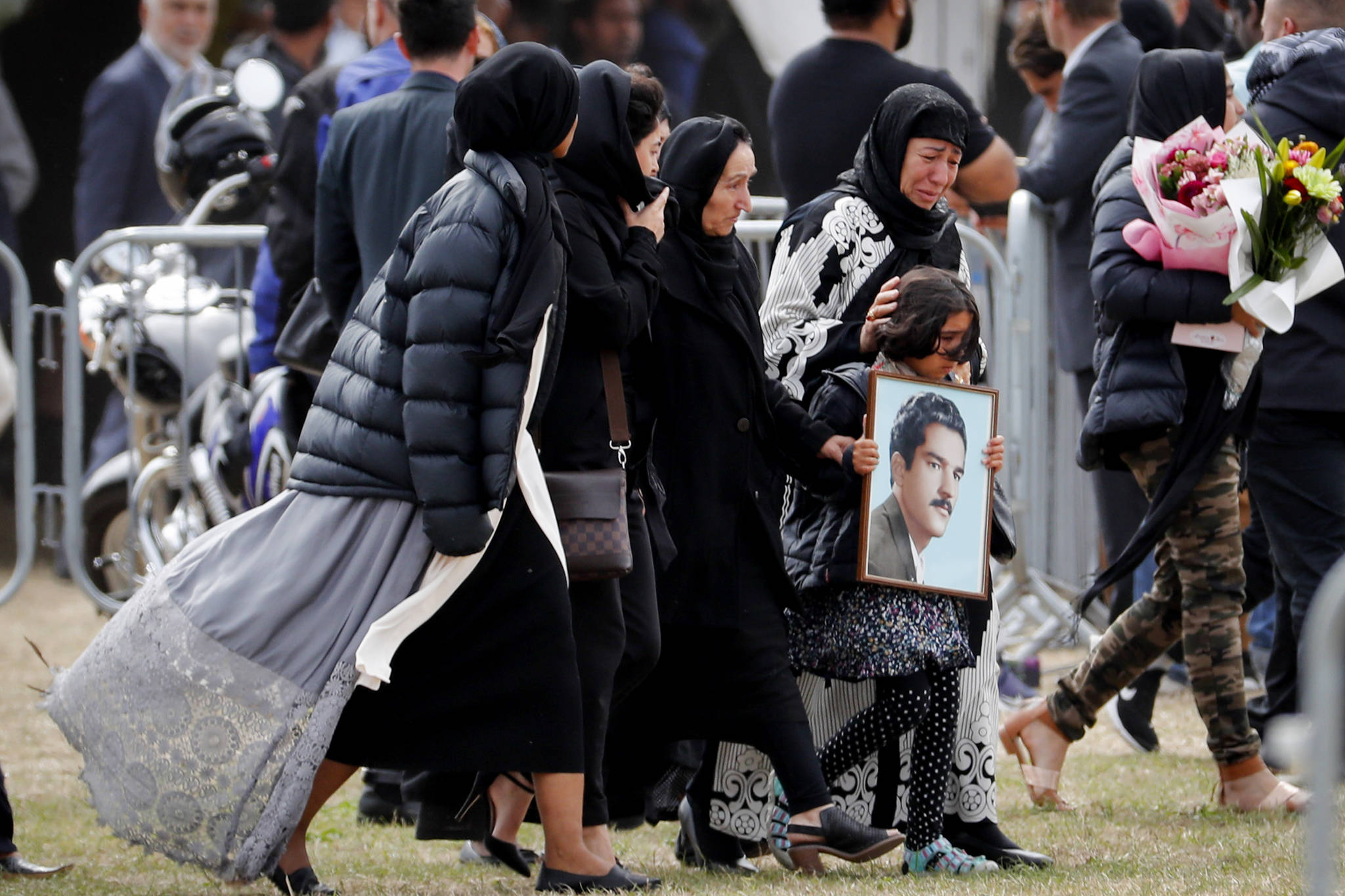 Mourners arrive for a burial service of a victim from the March 15 mosque shootings at the Memorial Park Cemetery in Christchurch, New Zealand on Thursday, March 21, 2019. (Vincent Thian | Associated Press)