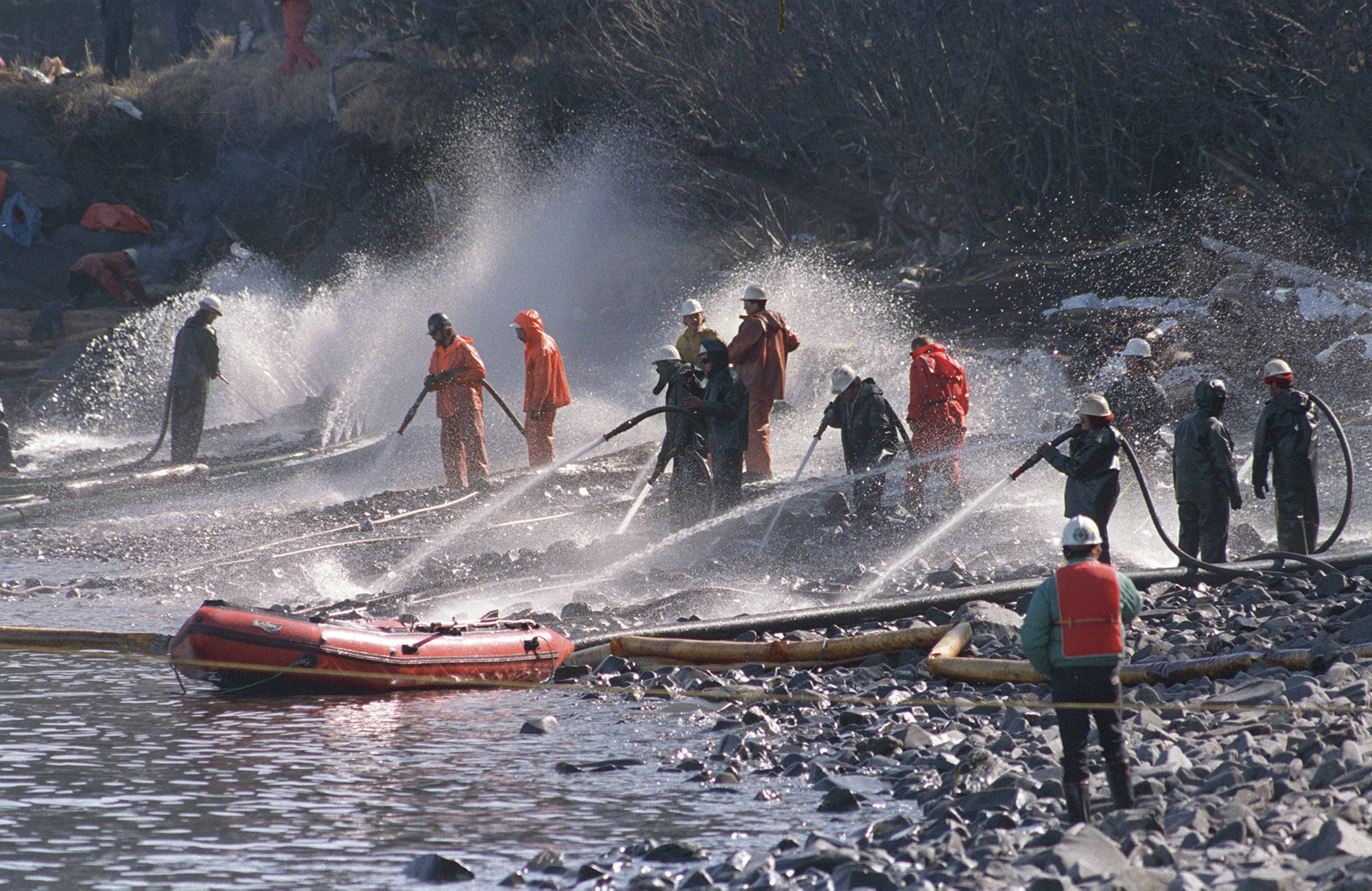 In this April 21, 1989 photo, crews use high pressured hoses to blast the rocks on this beachfront on Naked Island, Alaska. Just after midnight on March 24, 1989, an Exxon Shipping Co. tanker ran aground outside the town of Valdez, Alaska, spewing millions of gallons of thick, toxic crude oil into the pristine Prince William Sound. (Rob Stapleton | Associated Press File)
