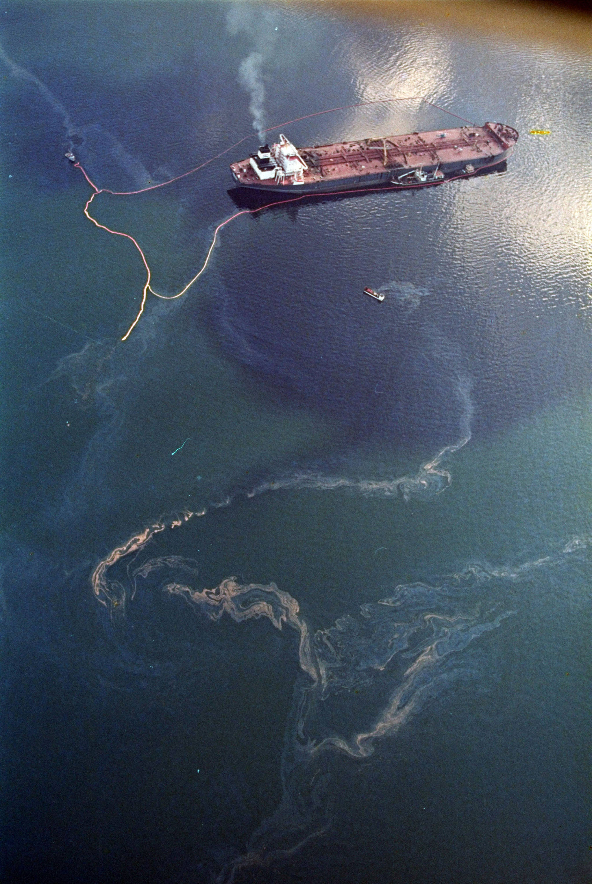 In this April 9, 1989 photo, crude oil from the tanker Exxon Valdez, top, swirls on the surface of Alaska’s Prince William Sound near Naked Island, days after the tanker ran aground, spilling millions of gallons of oil and causing widespread environmental damage. (John Gaps III | Associated Press File)