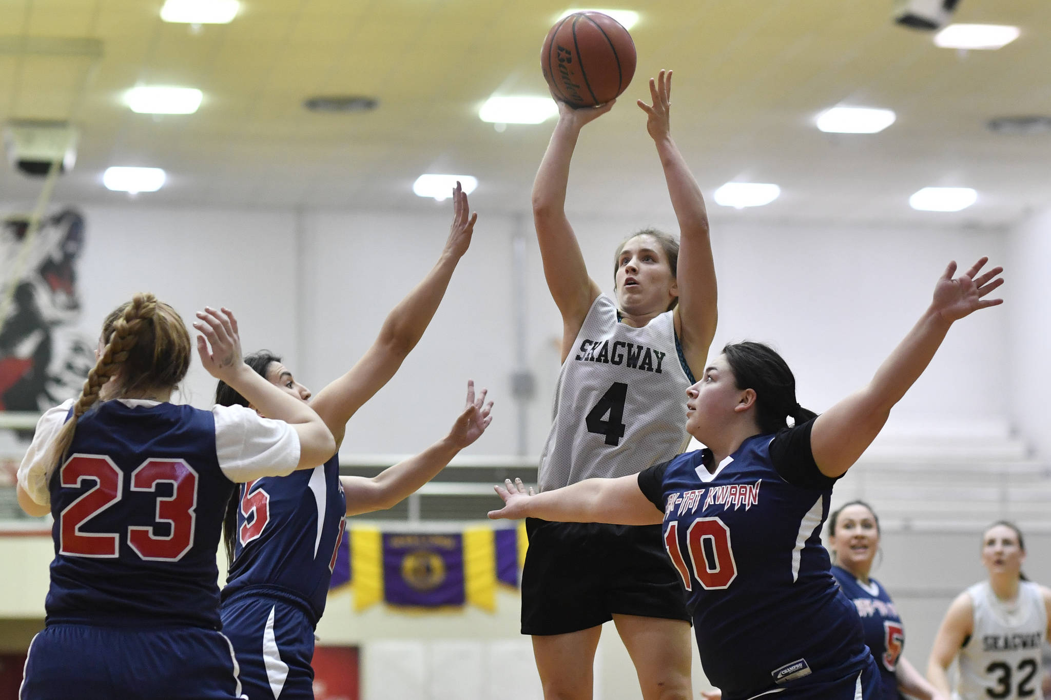 Haines’ Liz Segars, center, powers her way between Yakutat ‘s Violet Slatterly, left, and Janie Jensen at the Gold Medal Basketball Tournament on Friday, March 22, 2019. (Michael Penn | Juneau Empire)                                Skagway’s Kailyn Jerod shoots over Yakutat’s Cheyenne Ekis, left, Lorena Williams, center, and Nadine Fraker during the women’s bracket game at the Gold Medal Basketball Tournament on Thursday, March 21, 2019. (Michael Penn | Juneau Empire)