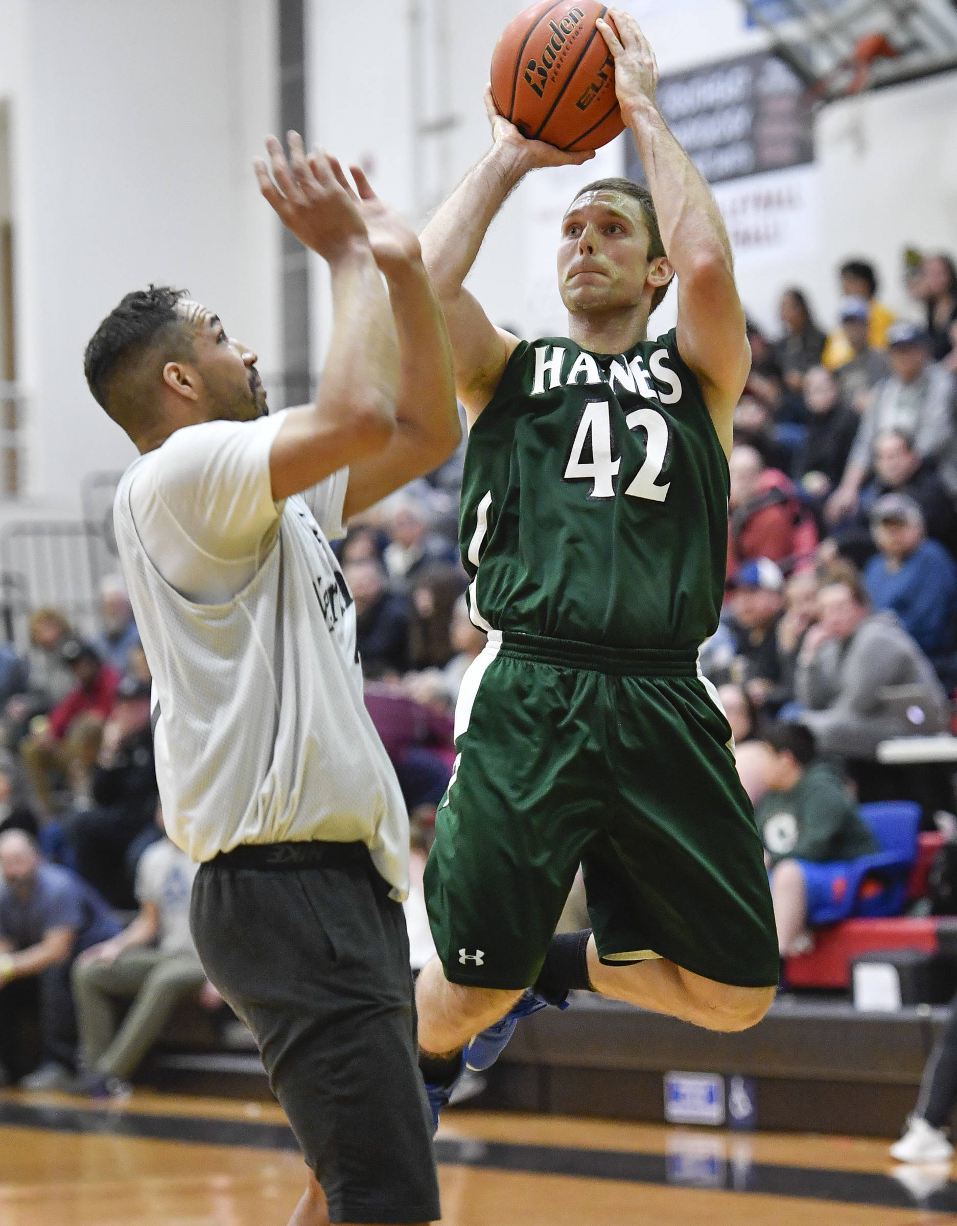 Haines’ Kyle Fossman, right, shoot against Metlakatla’s Chris Bryant in their B bracket game at the Juneau Lions Club 73rd Annual Gold Medal Basketball Tournament at Juneau-Douglas High School on Friday, March 22, 2019. (Michael Penn | Juneau Empire)