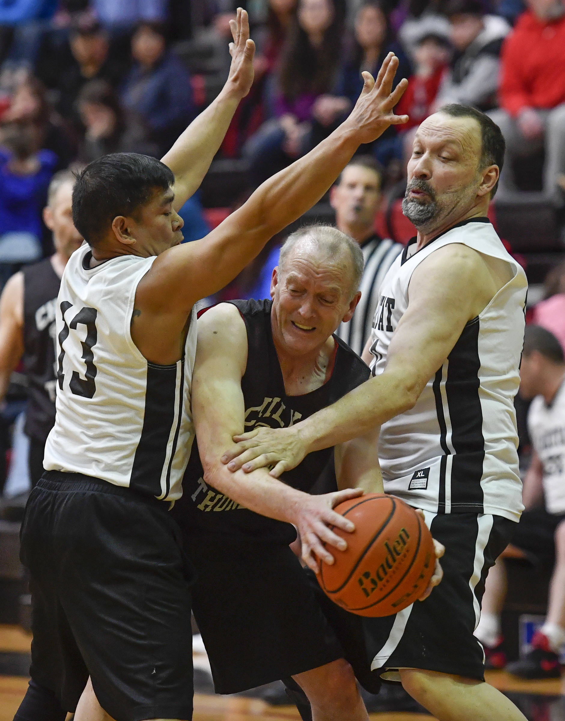 Klukwan’s Don Nash, center, is closely defended by Yakutat’s Jerry Riddington, left, and Greg Indreland during the Masters bracket game at the Juneau Lions Club 73rd Annual Gold Medal Basketball Tournament at Juneau-Douglas High School on Friday, March 22, 2019. Klukwan won 63-58. (Michael Penn | Juneau Empire)