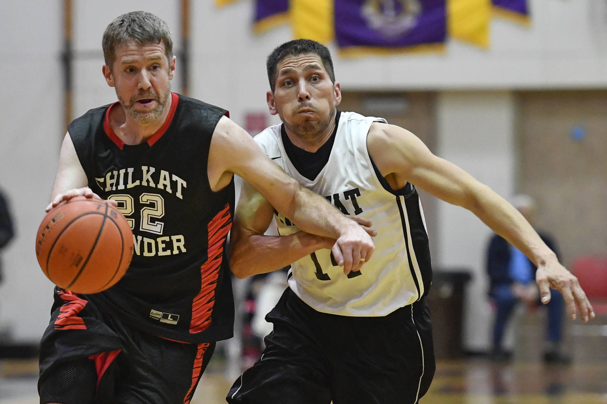 Klukwan’s Dave Buss drives to the basket against Yakutat’s Ralph Johnson during their Masters bracket game at the Juneau Lions Club 73rd Annual Gold Medal Basketball Tournament at Juneau-Douglas High School on Friday, March 22, 2019. Klukwan won 63-58. (Michael Penn | Juneau Empire)
