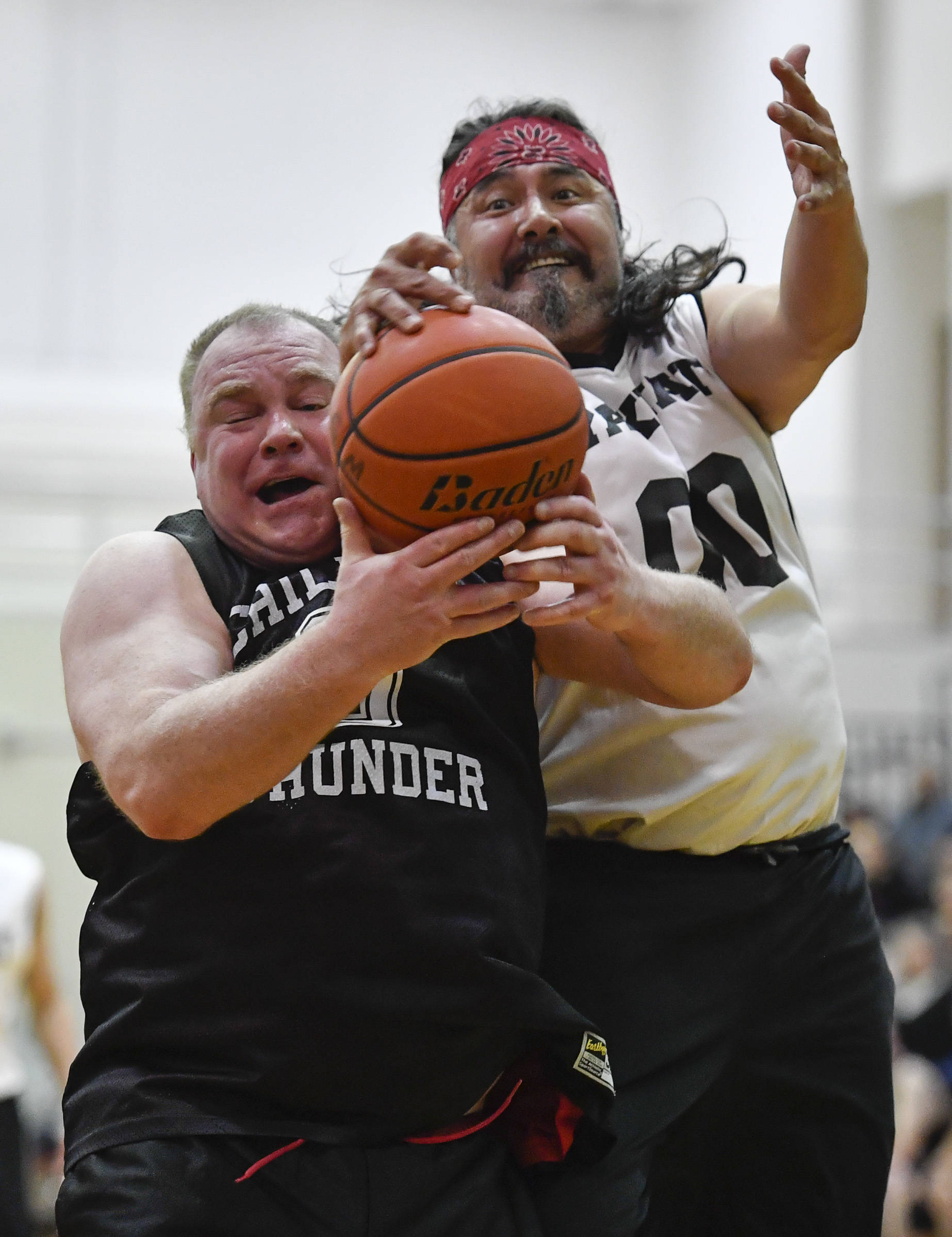 Klukwan’s Eric McCormick, left, and Yakutat’s Gary Klushkan battle for a rebound during their Masters bracket game at the Juneau Lions Club 73rd Annual Gold Medal Basketball Tournament at Juneau-Douglas High School on Friday, March 22, 2019. Klukwan won 63-58. (Michael Penn | Juneau Empire)
