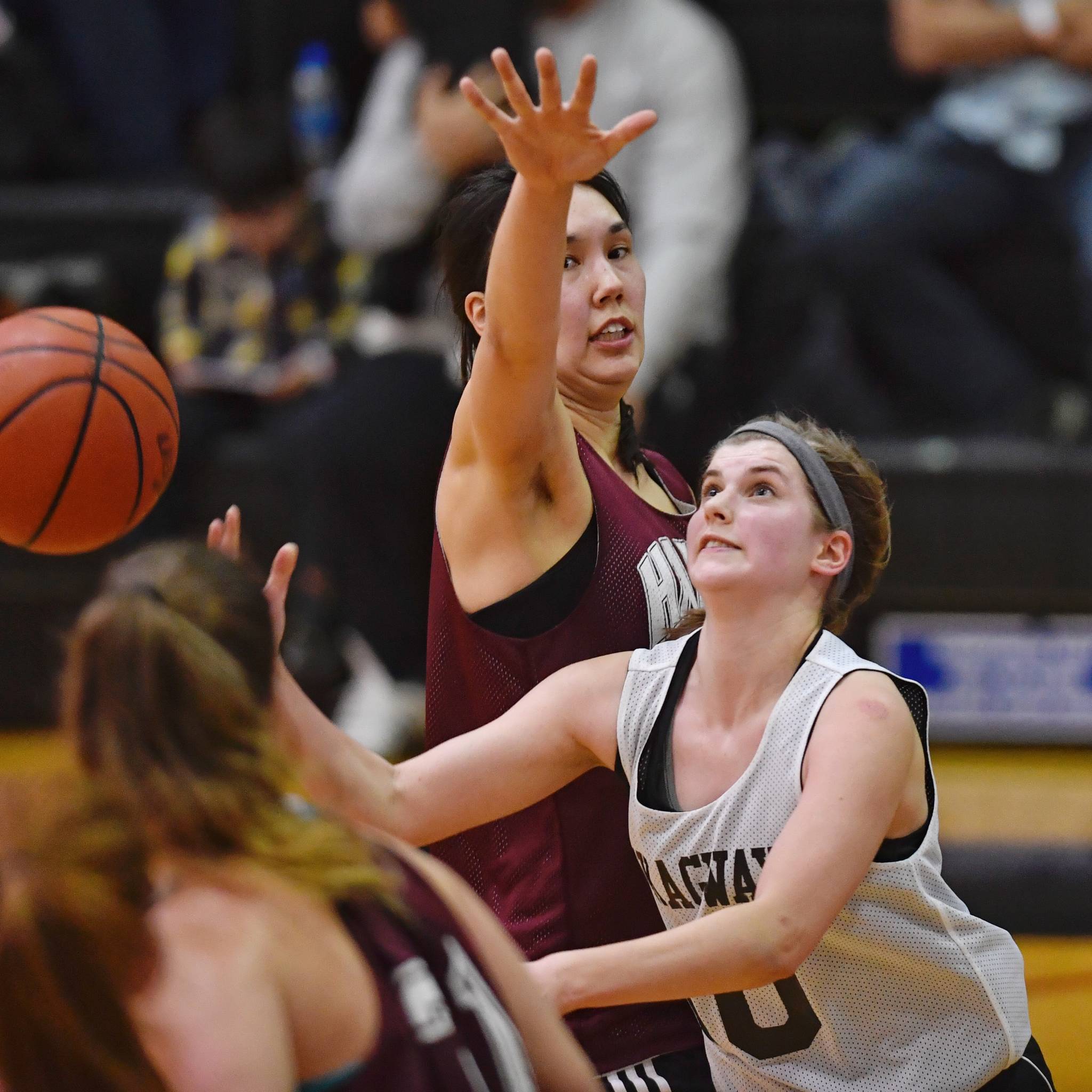 Skagway’s Kaylie Smith, right, shoots against Haines’ Fran Daly in the women’s final at the Gold Medal Basketball Tournament on Saturday, March 23, 2019. (Michael Penn | Juneau Empire)