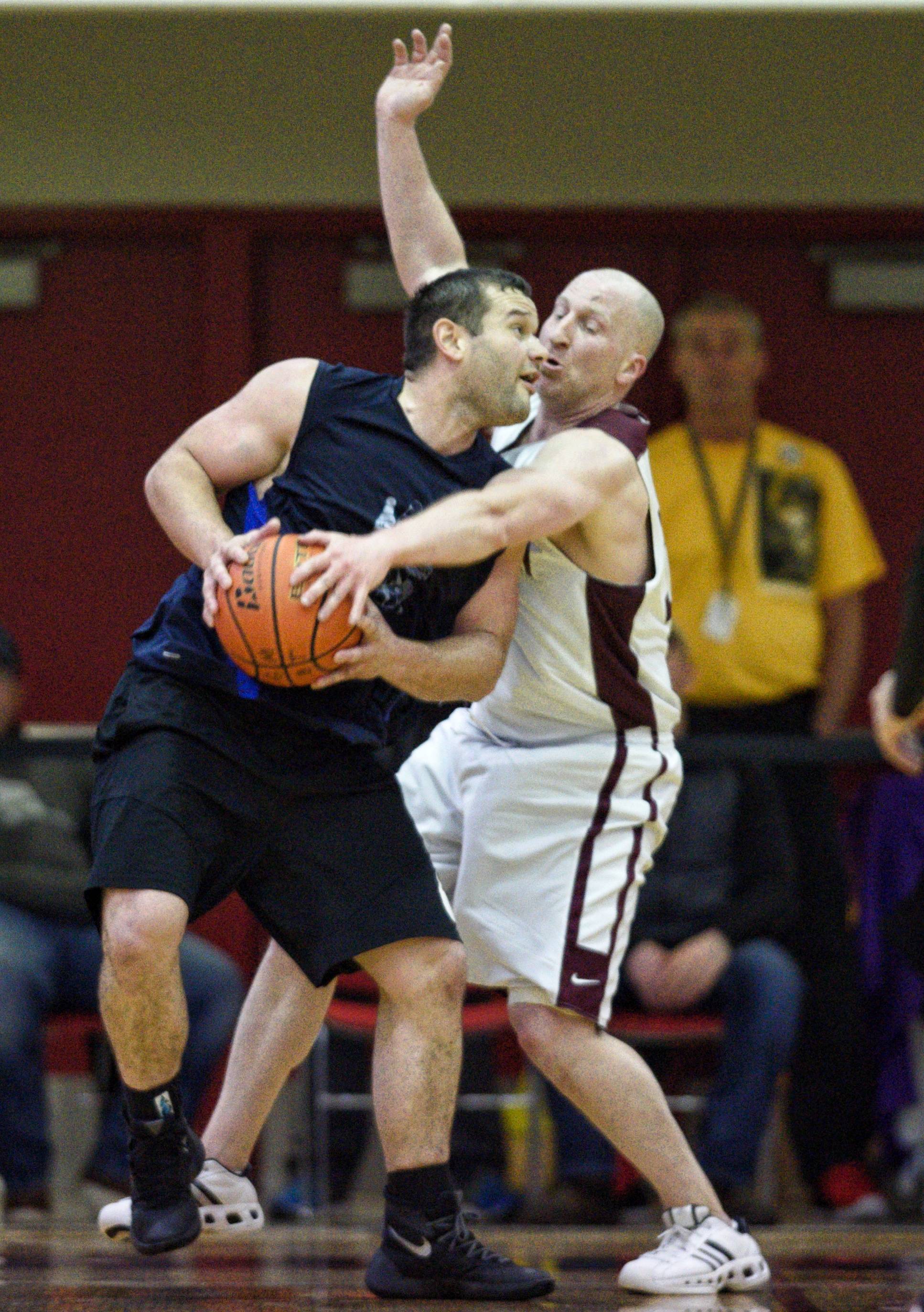 Hydaburg’s Fred Hamilton, left, is guarded by Klukwan’s Brian Friske in the C bracket final at the Gold Medal Basketball Tournament on Saturday, March 23, 2019. (Michael Penn | Juneau Empire)