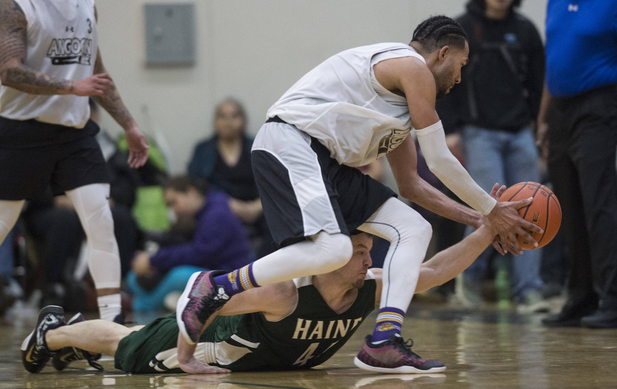 Haines’ Brian Combs, below, and Angoon’s Clayton Edwin chase a loose ball the B final at the Gold Medal Basketball Tournament on Saturday, March 23, 2019. Haines won 88-80. (Michael Penn | Juneau Empire)