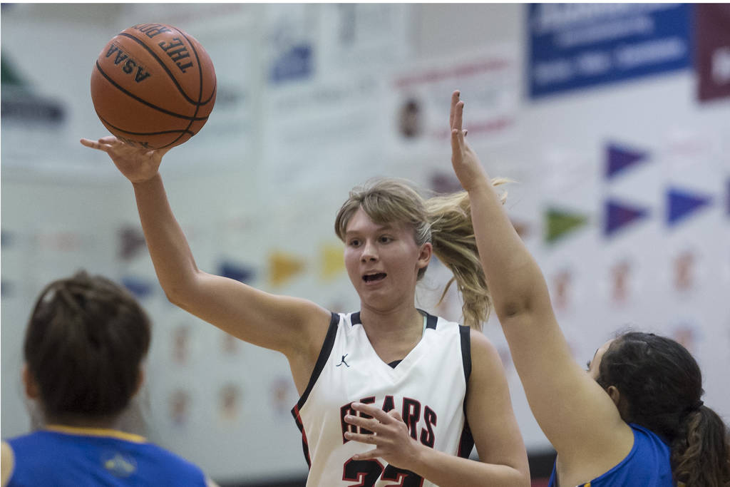 Juneau-Douglas Caitlin Pusich passes to a teammate against Barrow at the Princess Cruises Capital City Classic at Juneau-Douglas High School on Friday, Dec. 28, 2018. (Michael Penn | Juneau Empire)