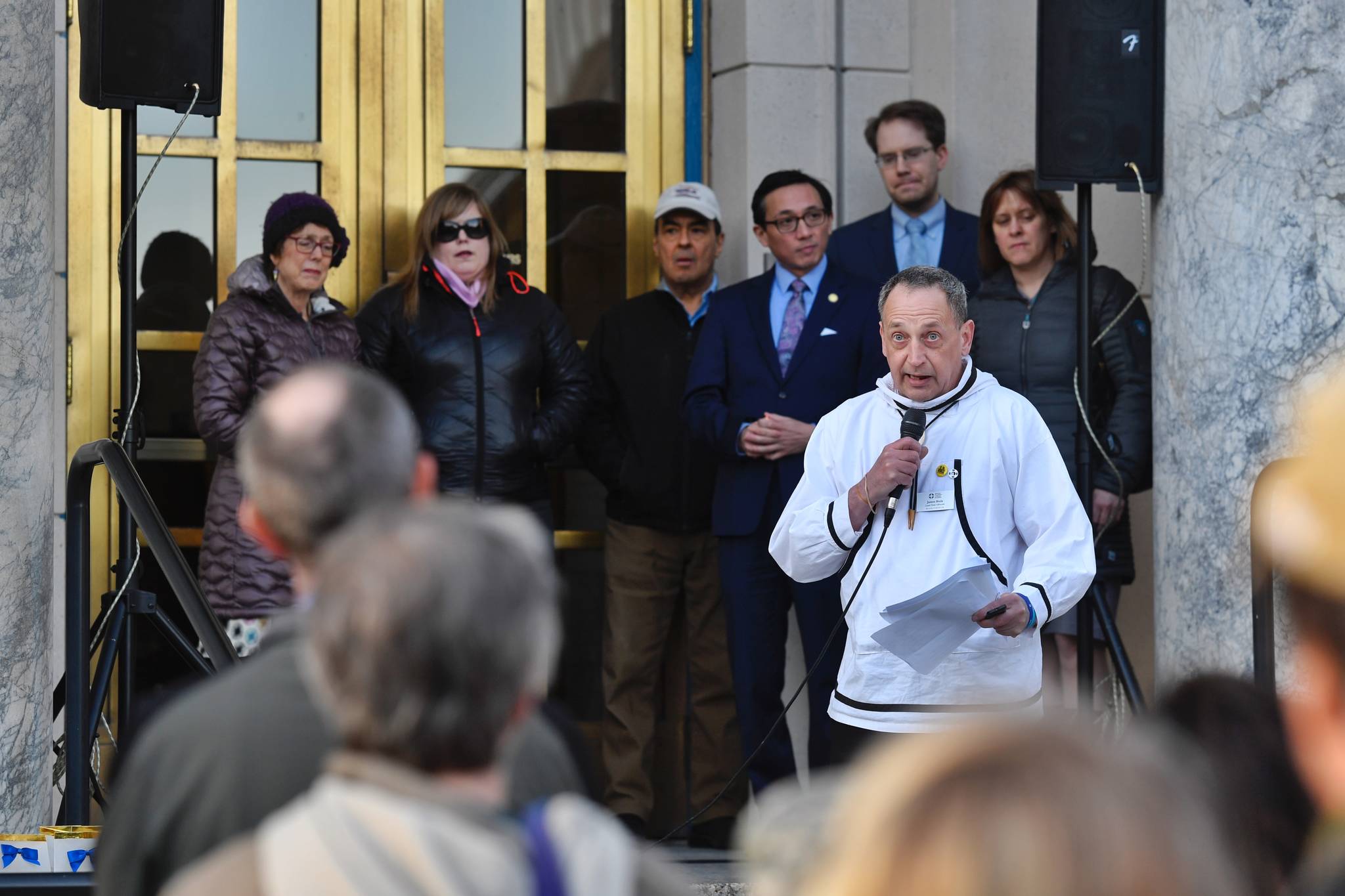 Backed by Alaska legislators, James Biela, lead field advocate the Alaska Chapter of the American Foundation for Suicide Prevention, speaks at a candlelight vigil to raise awareness at the Capitol on Tuesday, March 26, 2019. (Michael Penn | Juneau Empire)