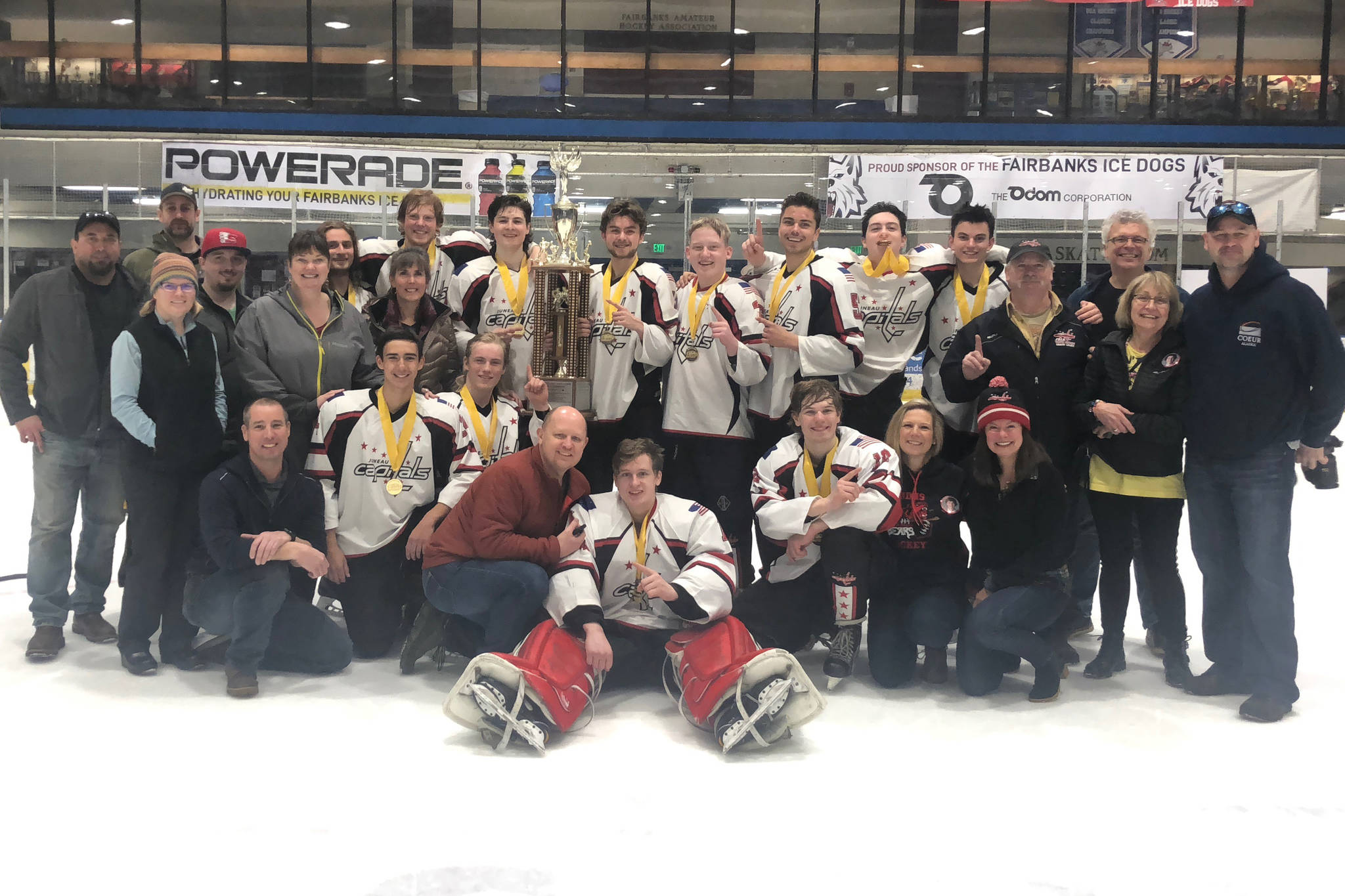 The Juneau Capitals 18U hockey team poses with family after winning the Alaska State Hockey Association Tier A state championship at the Big Dipper Ice Arena in Fairbanks on Sunday, March 24, 2019. The Capitals defeated the Alaska Heat 5-3 in the title game to round out a 5-0 showing at the tournament. (Courtesy Photo | Ian Leary)