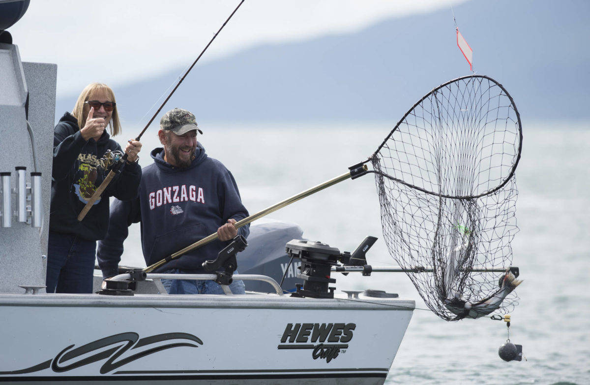Scott and Shari Guenther pull in a catch during the 72nd Annual Golden North Salmon Derby on Friday, August 17, 2018, sponsored by the Territorial Sportsmen. (Michael Penn | Juneau Empire File)