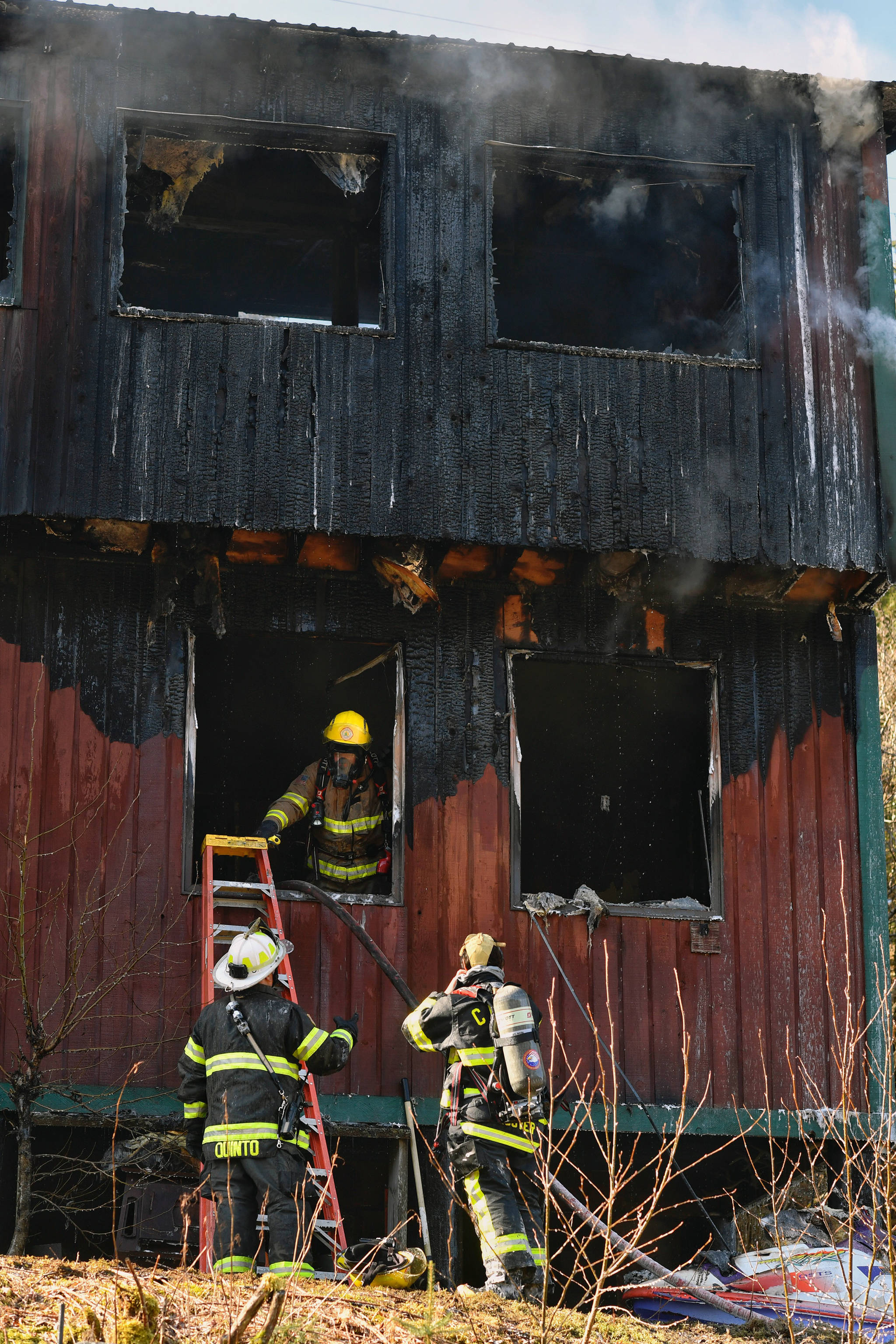 Firefighters work a house fire on North Douglas Highway on Thursday, March 28, 2019. (Michael Penn | Juneau Empire)