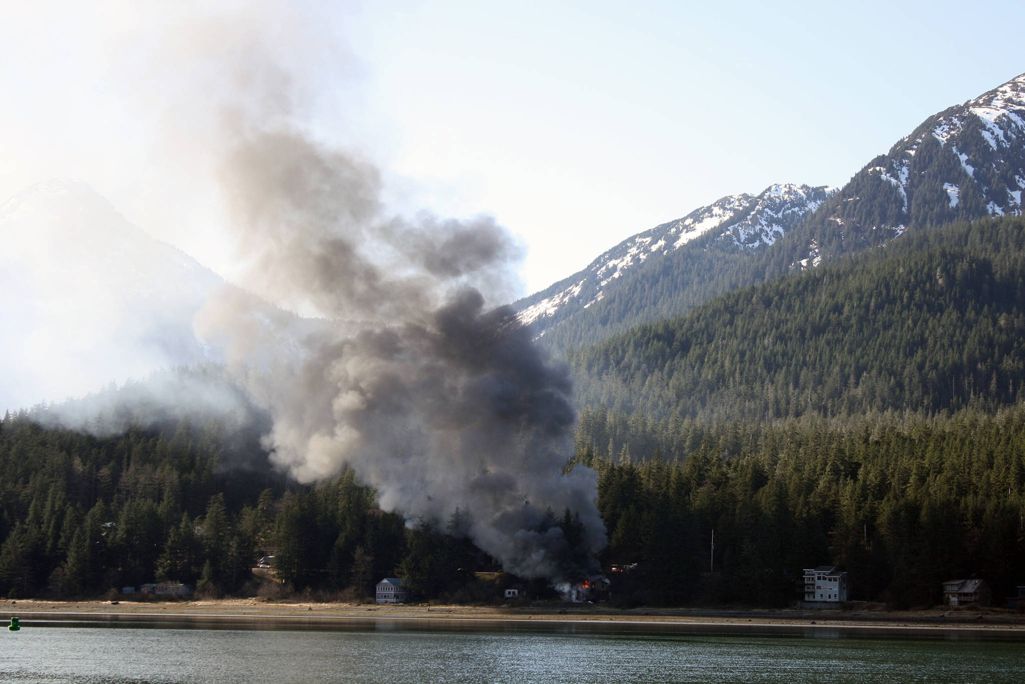 A house fire is seen on North Douglas from the view across Gastineau Channel from the Juneau Empire offices, Thursday, March 28, 2019. (Emily Russo Miller | Juneau Empire)