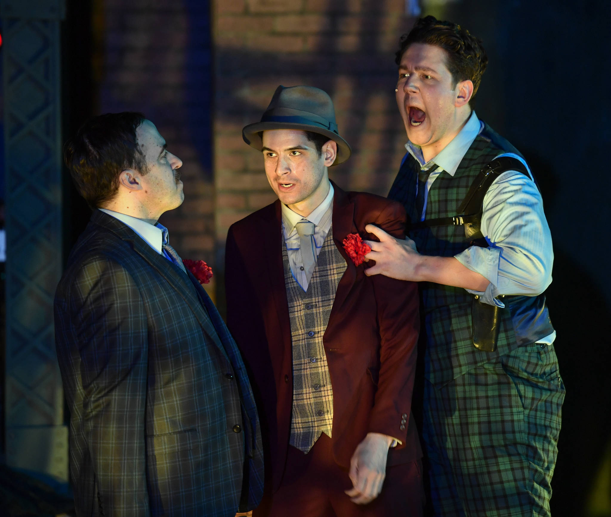 James Sullivan, left, as Nathan Detroit faces some heat from Felix Thillet, middle, as Harry the Horse and Evan Carson, right, as Big Jule during a performance of “Guys and Dolls” at Perseverance Theatre on Thursday, March 14, 2019. (Michael Penn | Juneau Empire)