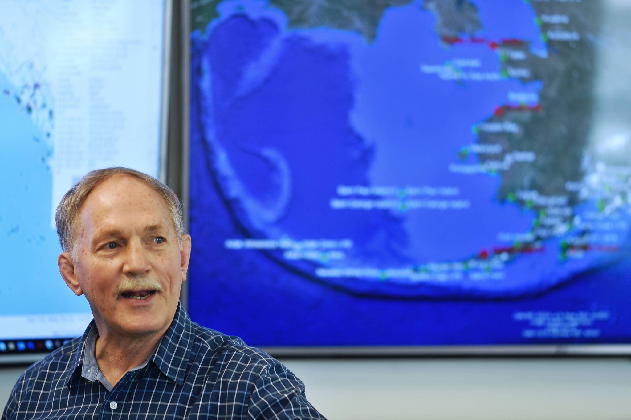 Retired U.S. Coast Guard Captain Ed Page, Executive Director of the Alaska Marine Exchange, explains Wednesday, March 27, 2019, how the exchange came about and how it now keeps track of ships in Alaska waters and beyond. (Michael Penn | Juneau Empire)