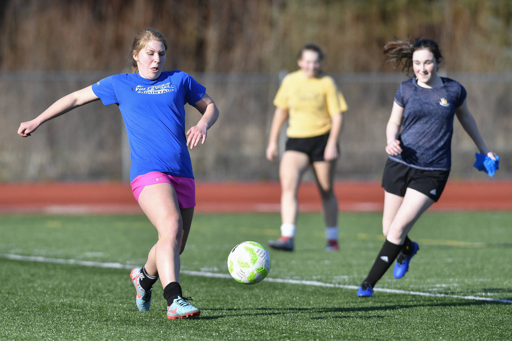 Sally Thompson, left, keeps the ball away from Alina Renz, right, during Thunder Mountain High School girls soccer practice on Friday, March 29, 2019. (Michael Penn | Juneau Empire)